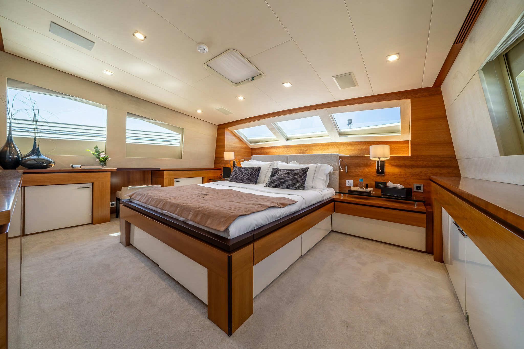 a bedroom with a bed and a desk aboard ARION Yacht for Sale