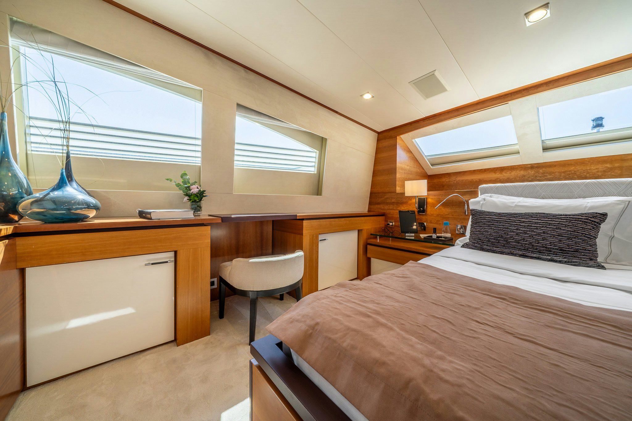 a bedroom with a desk and a bed aboard ARION Yacht for Sale