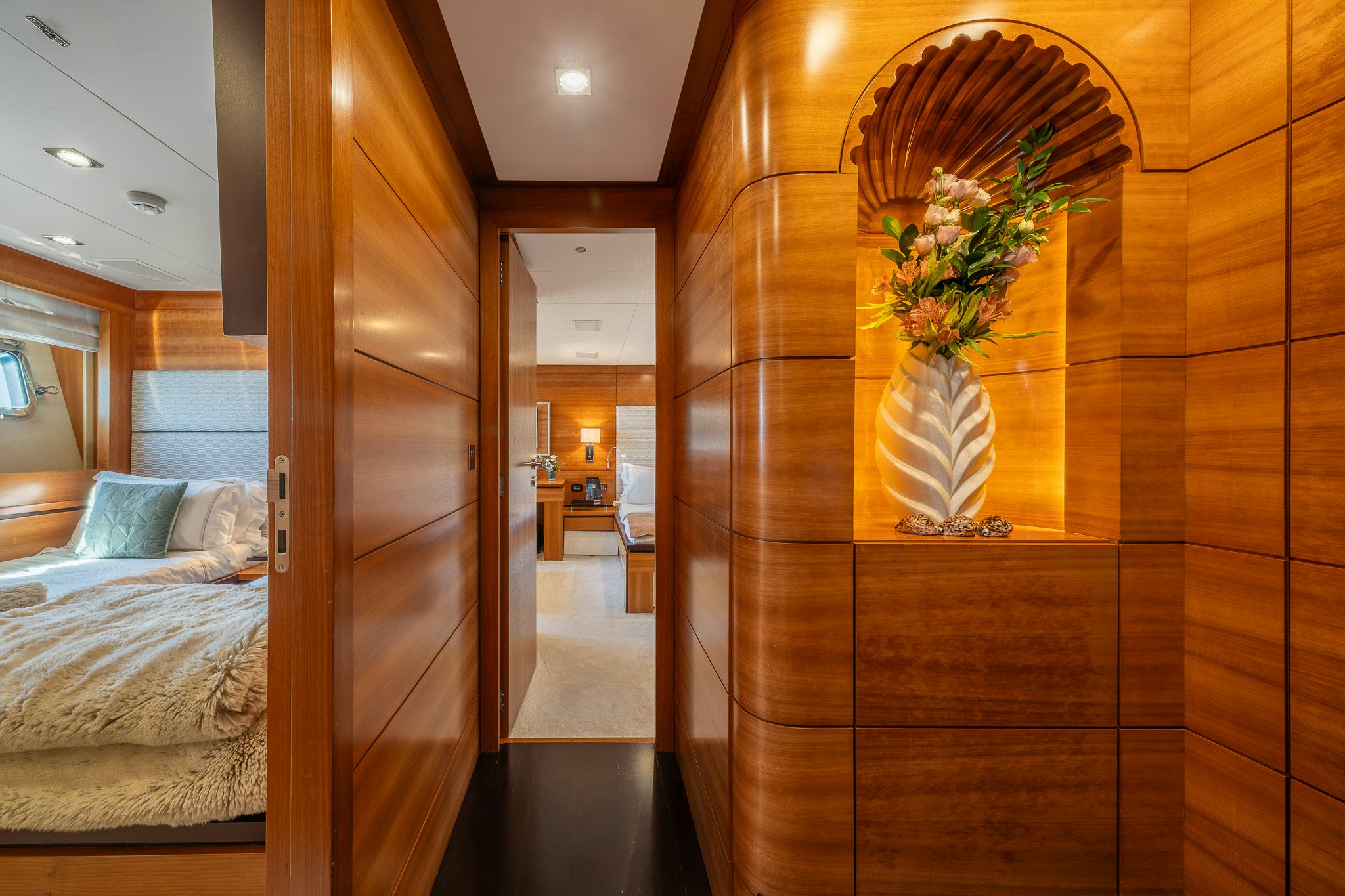 a room with a wood door and a vase with flowers in it aboard ARION Yacht for Sale