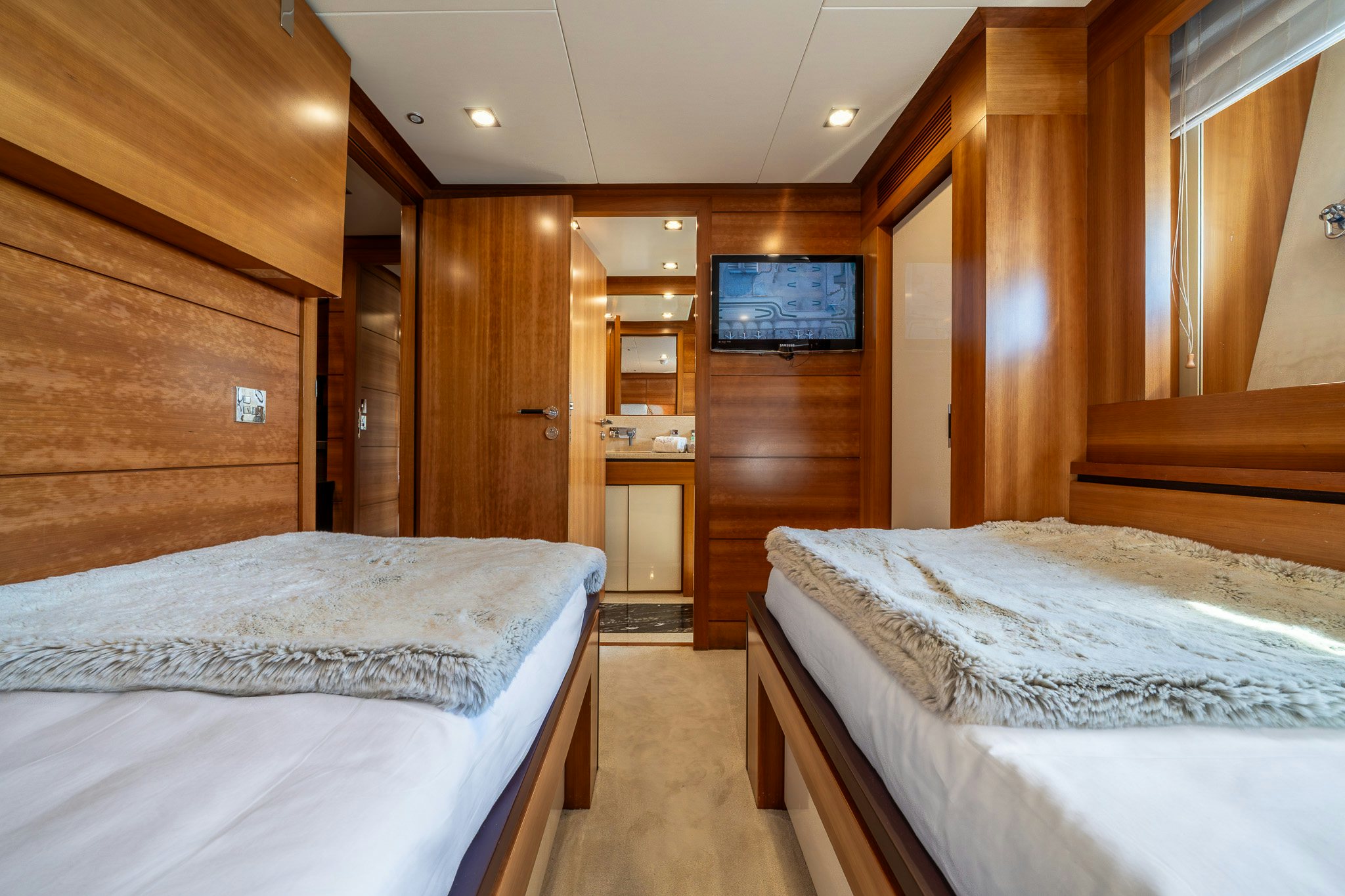 a room with wooden walls and a couple of beds aboard ARION Yacht for Sale