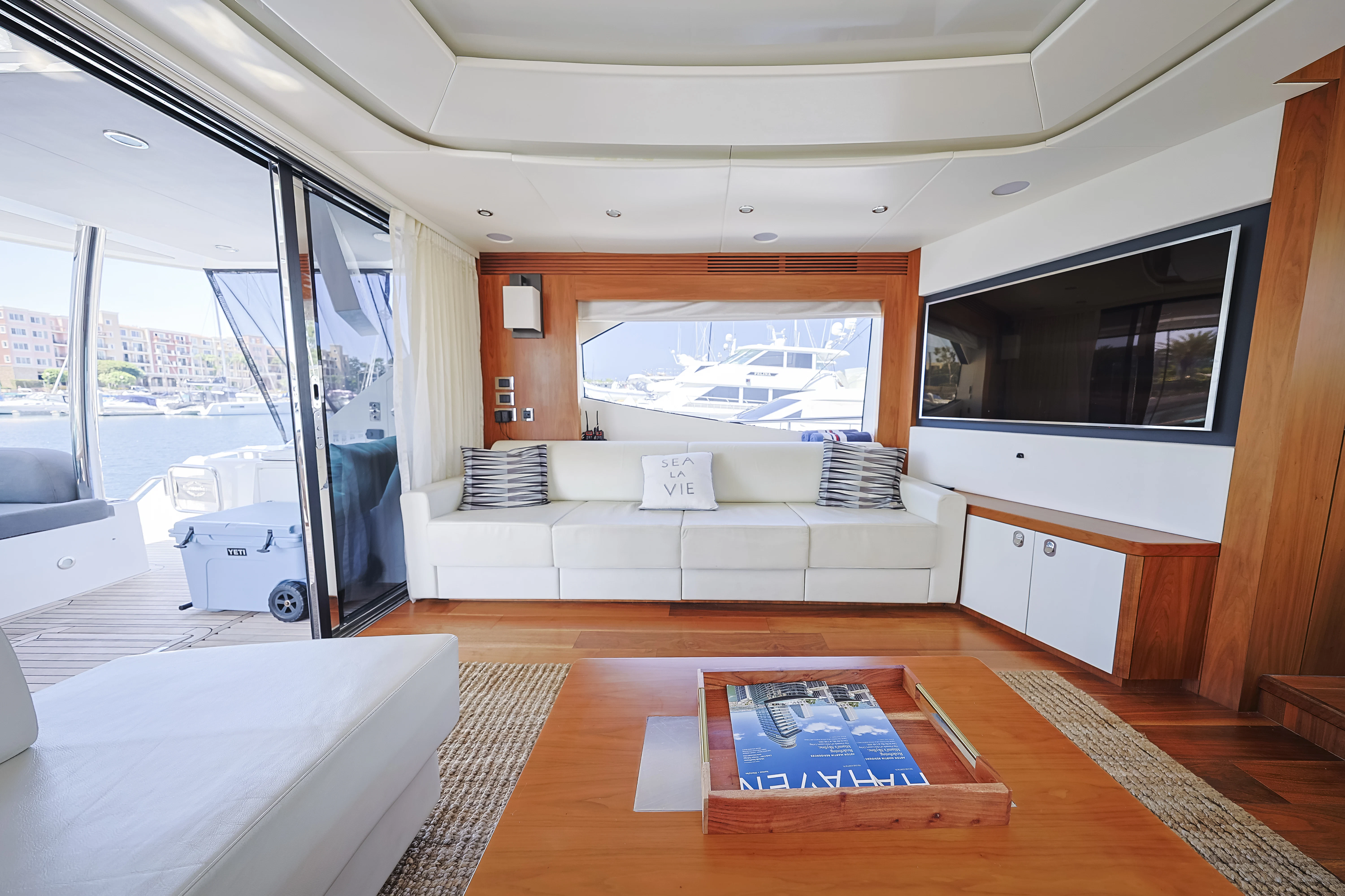 a room with a bed and a large window aboard SEA LA VIE Yacht for Sale