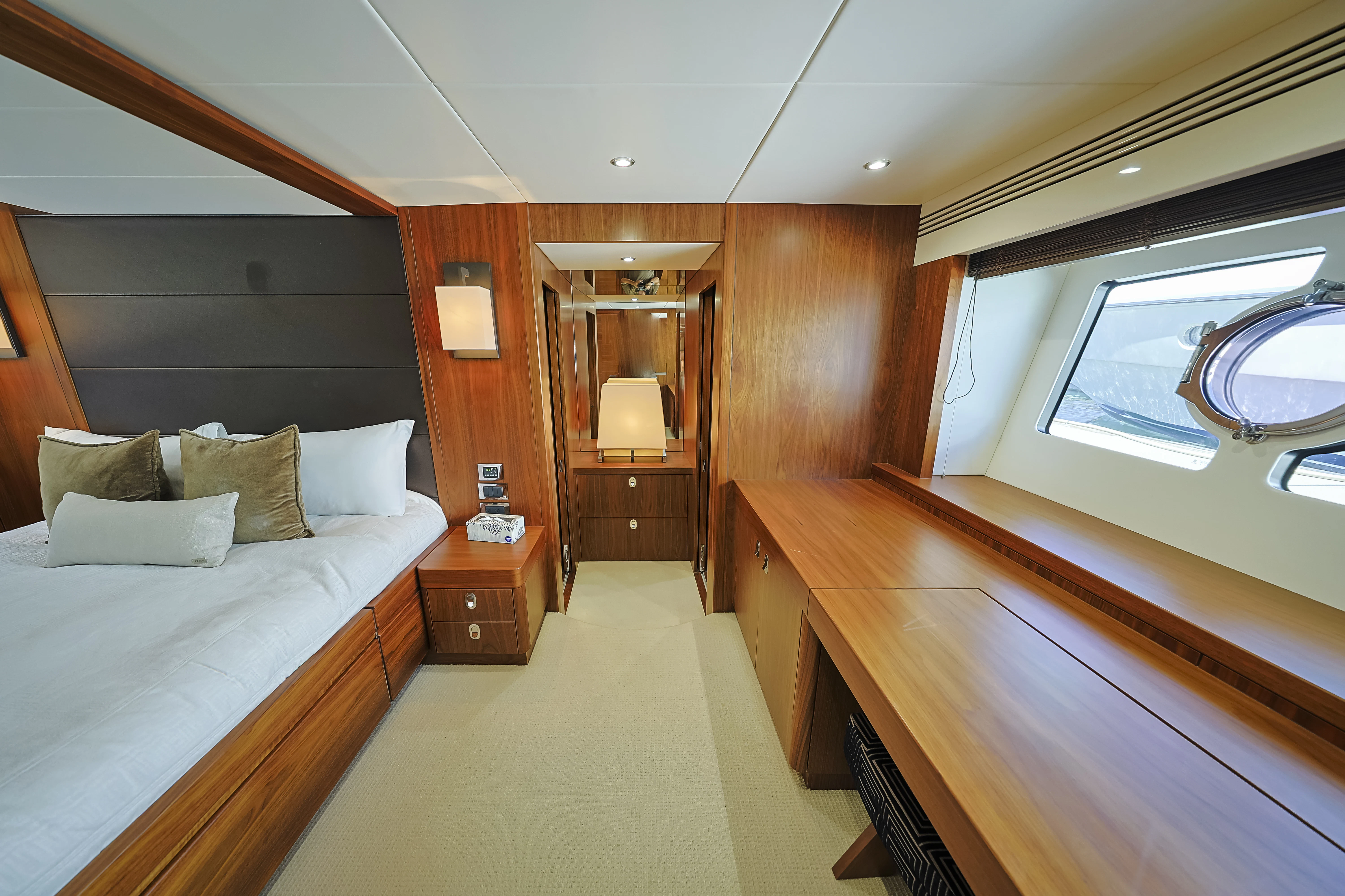a room with a bed and a mirror aboard SEA LA VIE Yacht for Sale