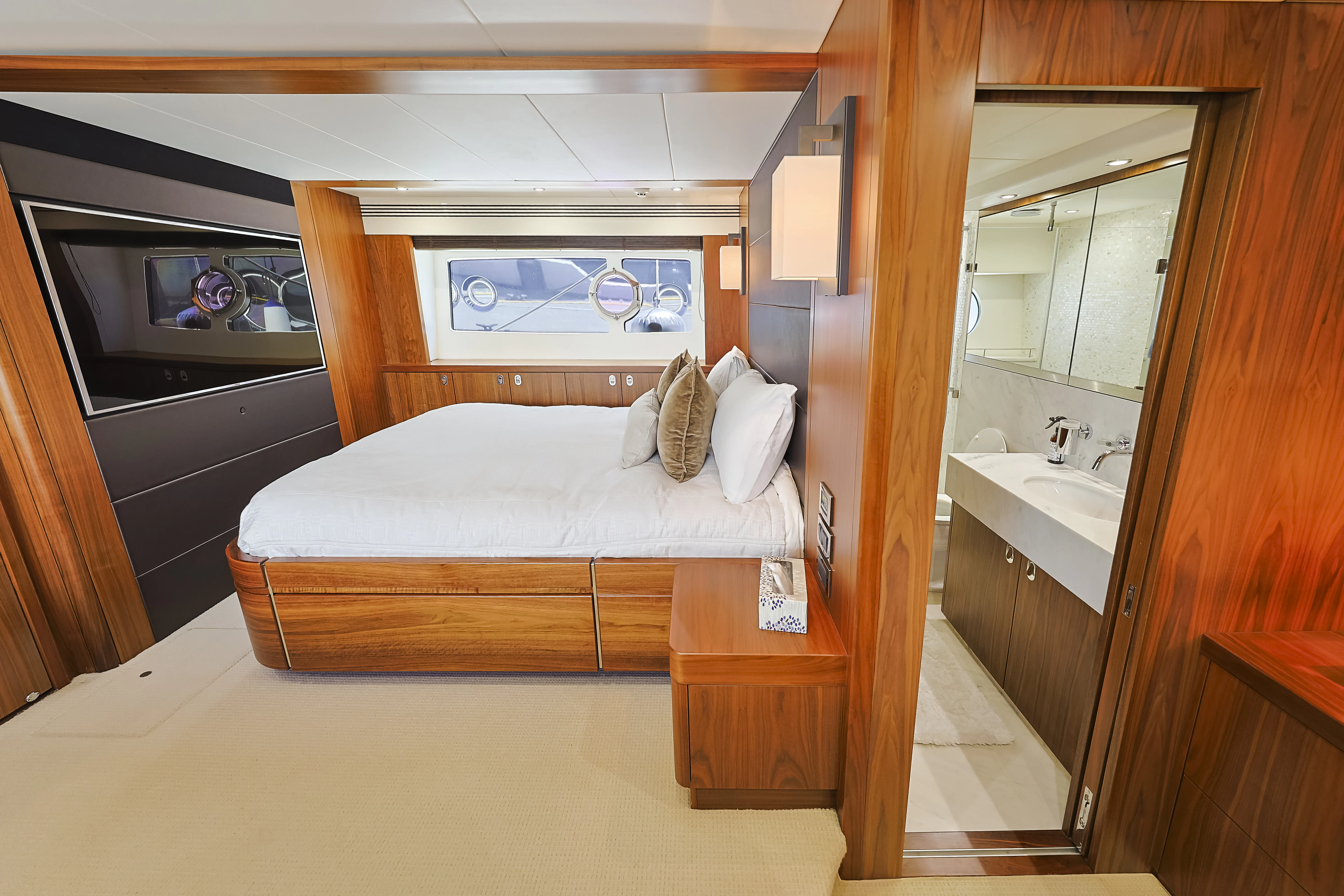 a bedroom with a bed and sink aboard SEA LA VIE Yacht for Sale