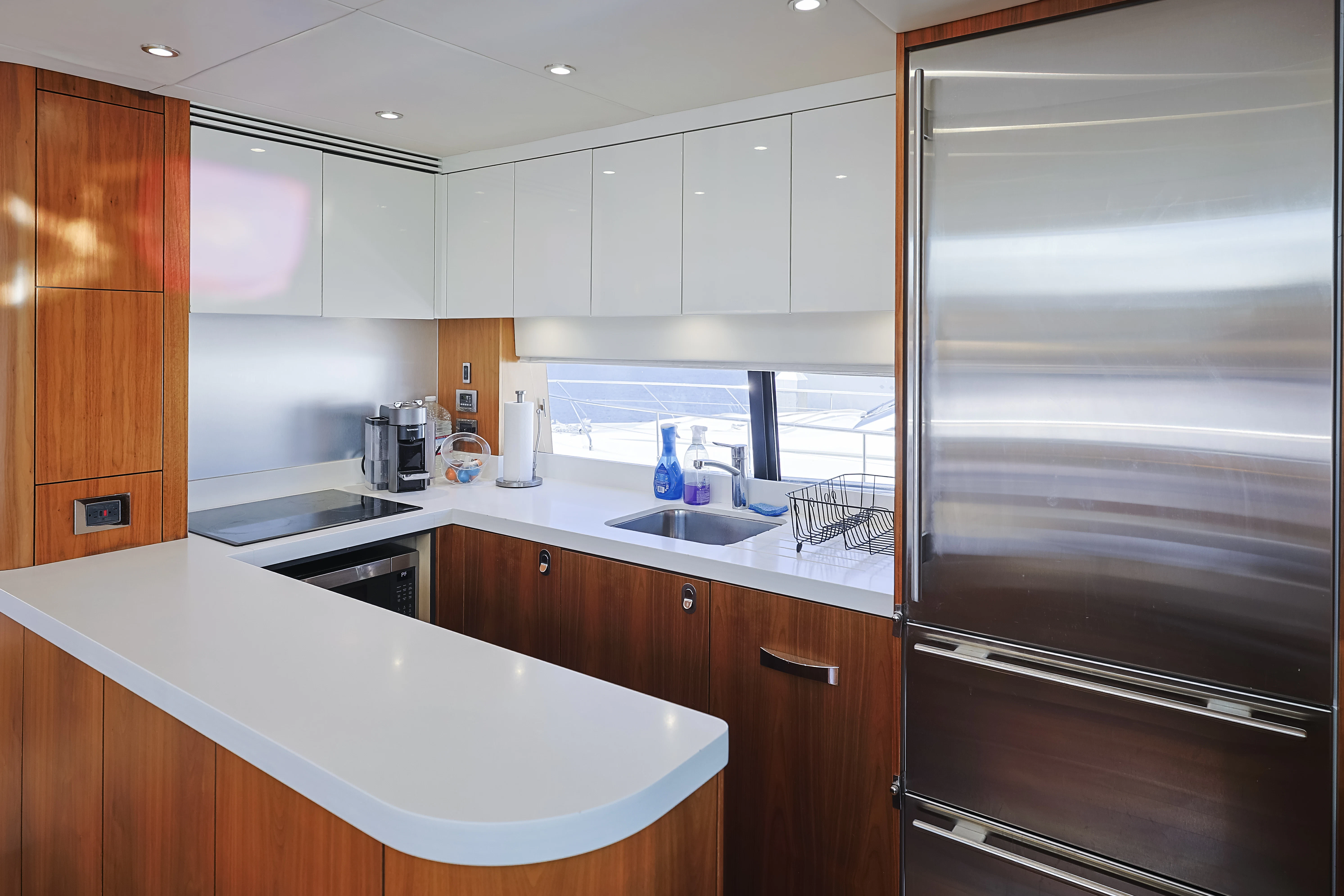 a kitchen with white cabinets aboard SEA LA VIE Yacht for Sale