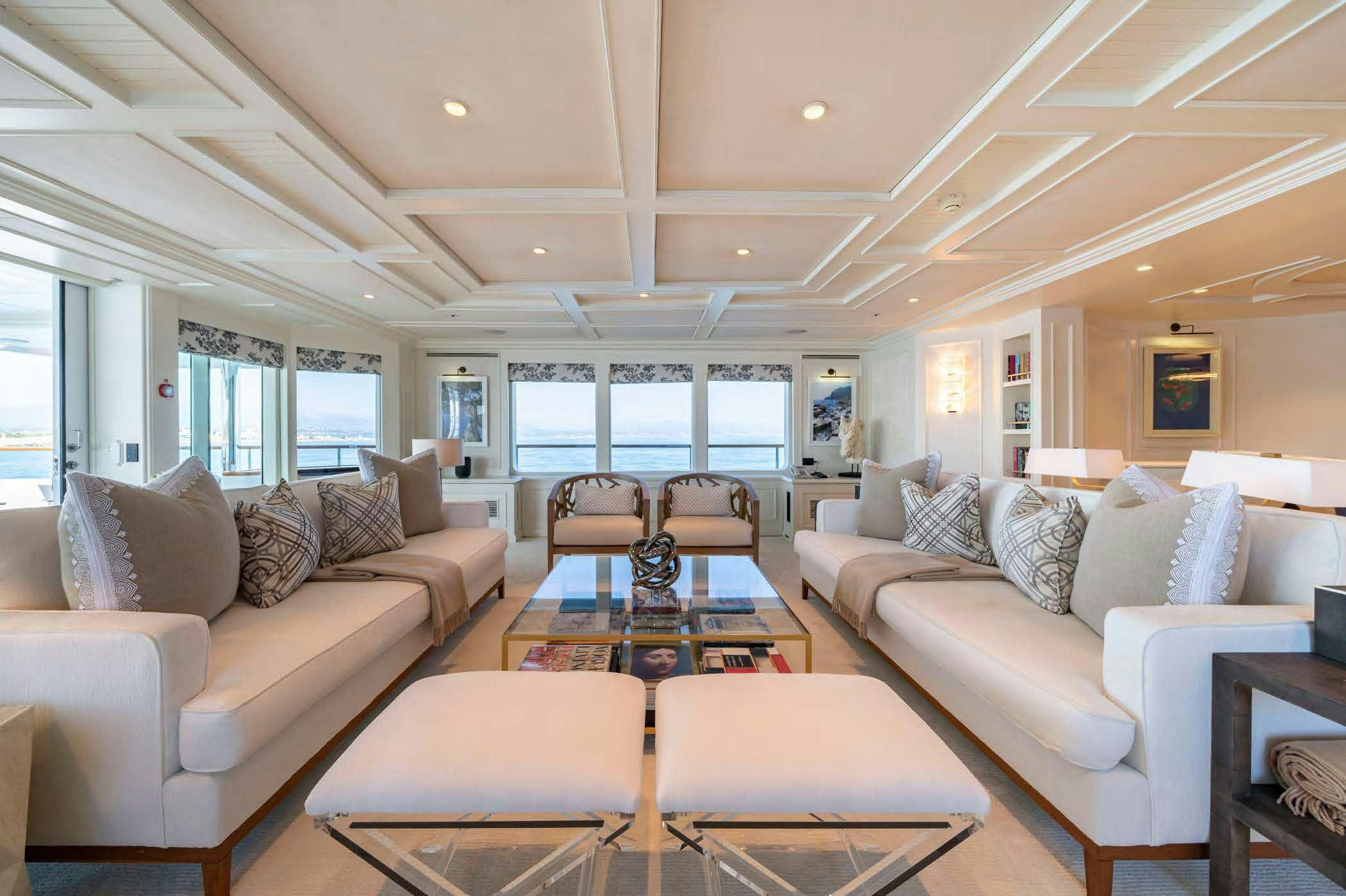 a living room with a couch and a table aboard MOSAIQUE Yacht for Sale