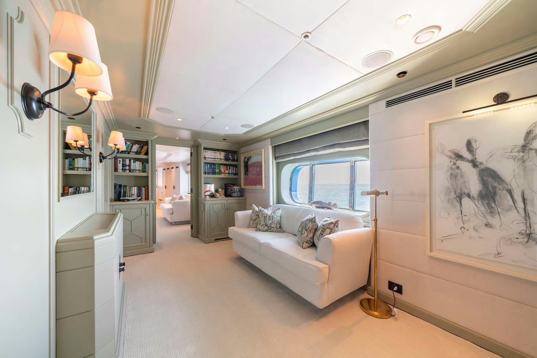 a living room with a white couch aboard MOSAIQUE Yacht for Sale