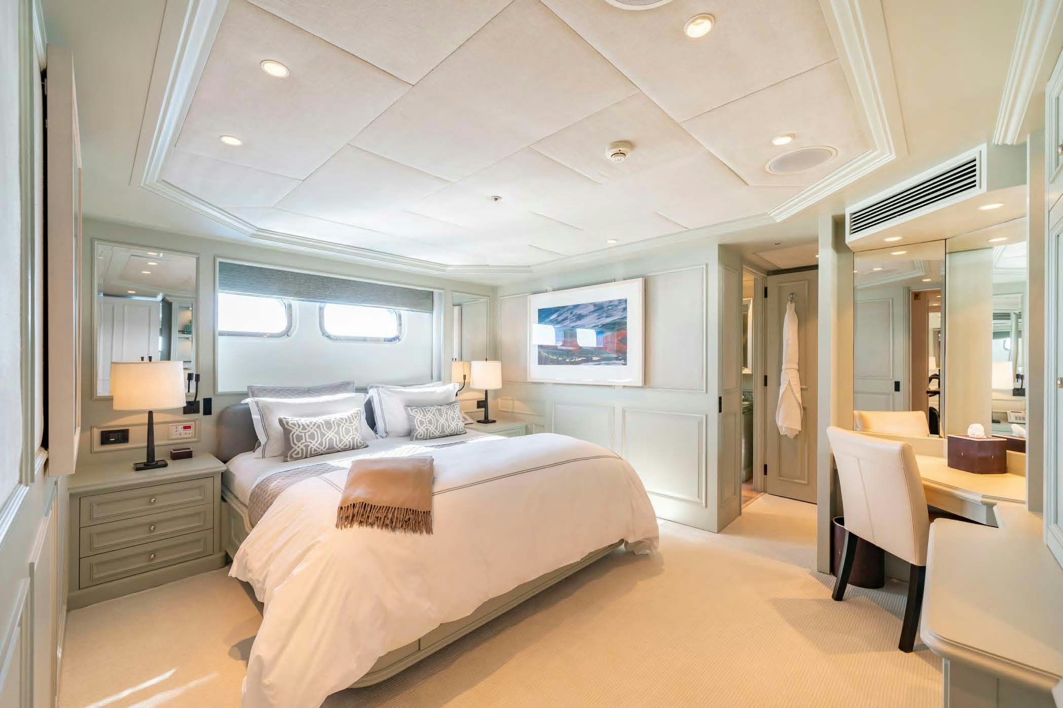 a bedroom with a bed and a desk aboard MOSAIQUE Yacht for Sale