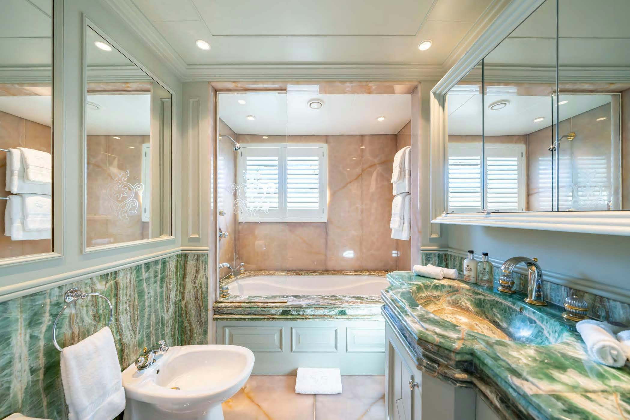 a bathroom with a large tub aboard MOSAIQUE Yacht for Sale