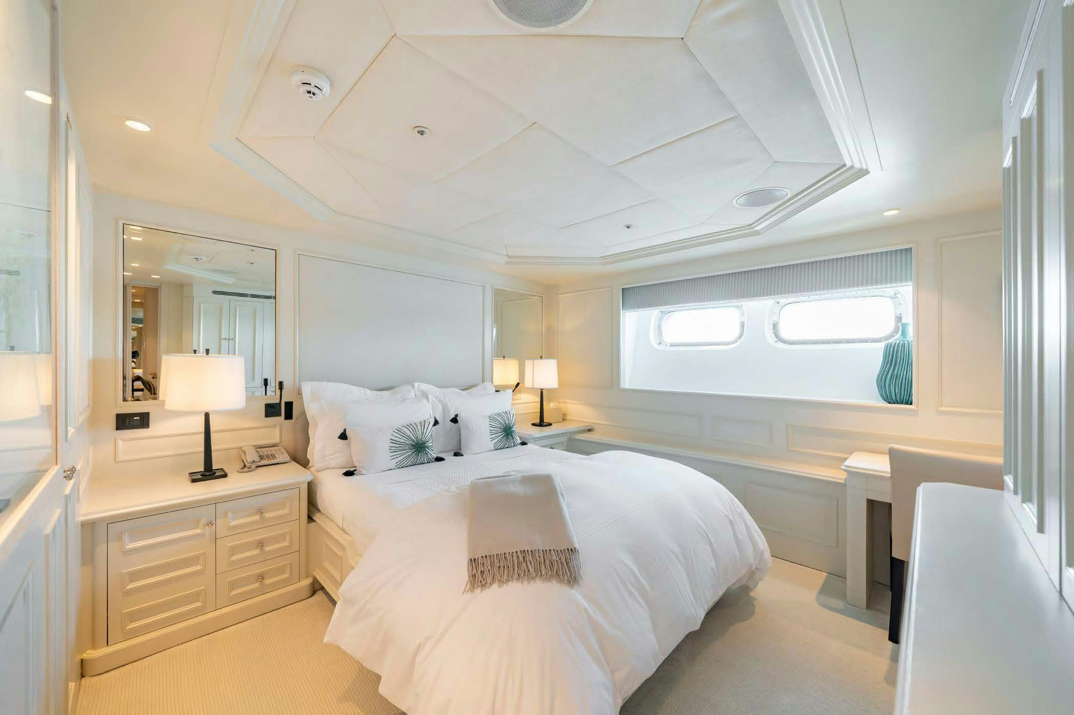 a room with a bed and a desk aboard MOSAIQUE Yacht for Sale