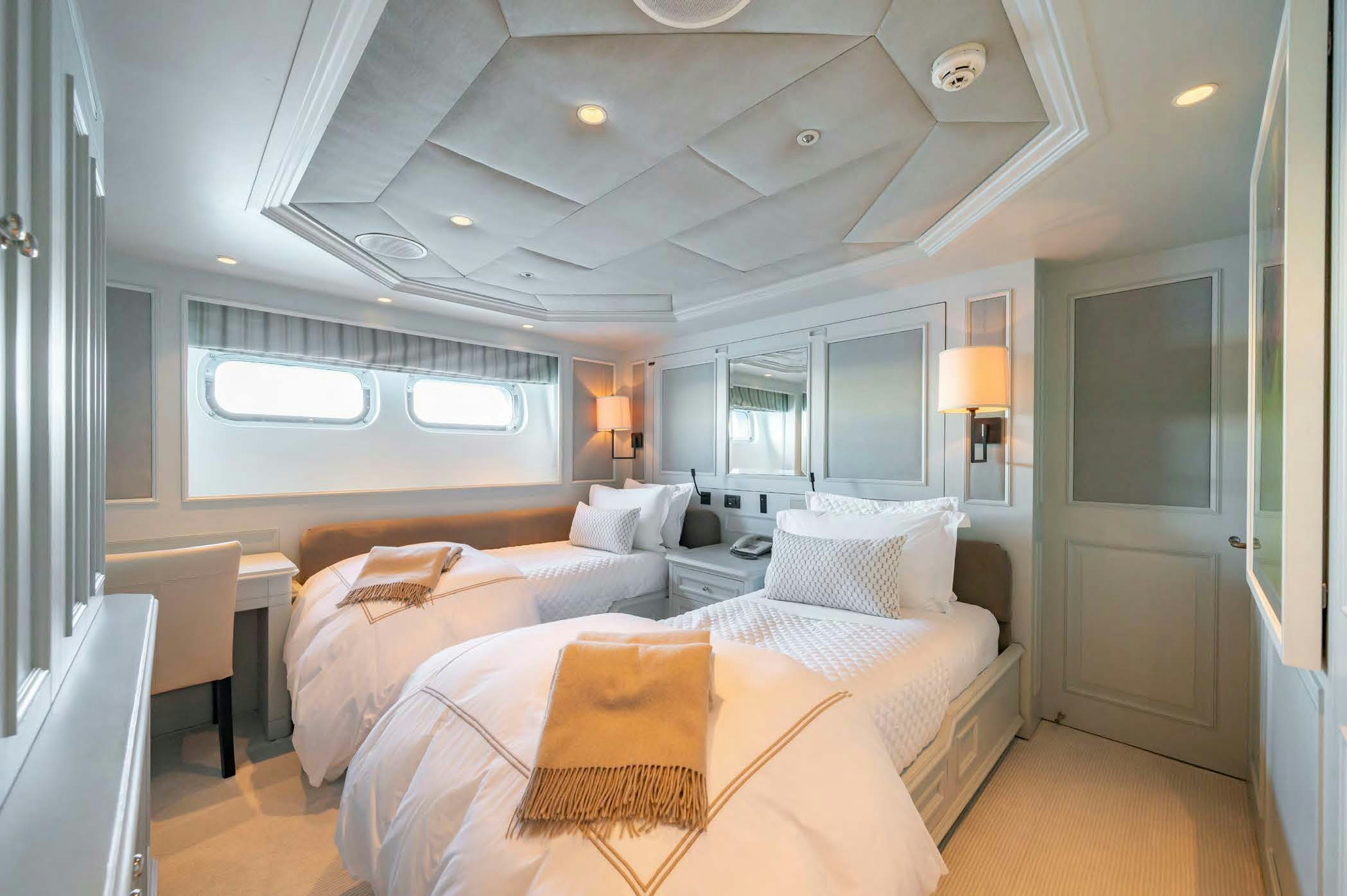 a room with a bed and a window aboard MOSAIQUE Yacht for Sale