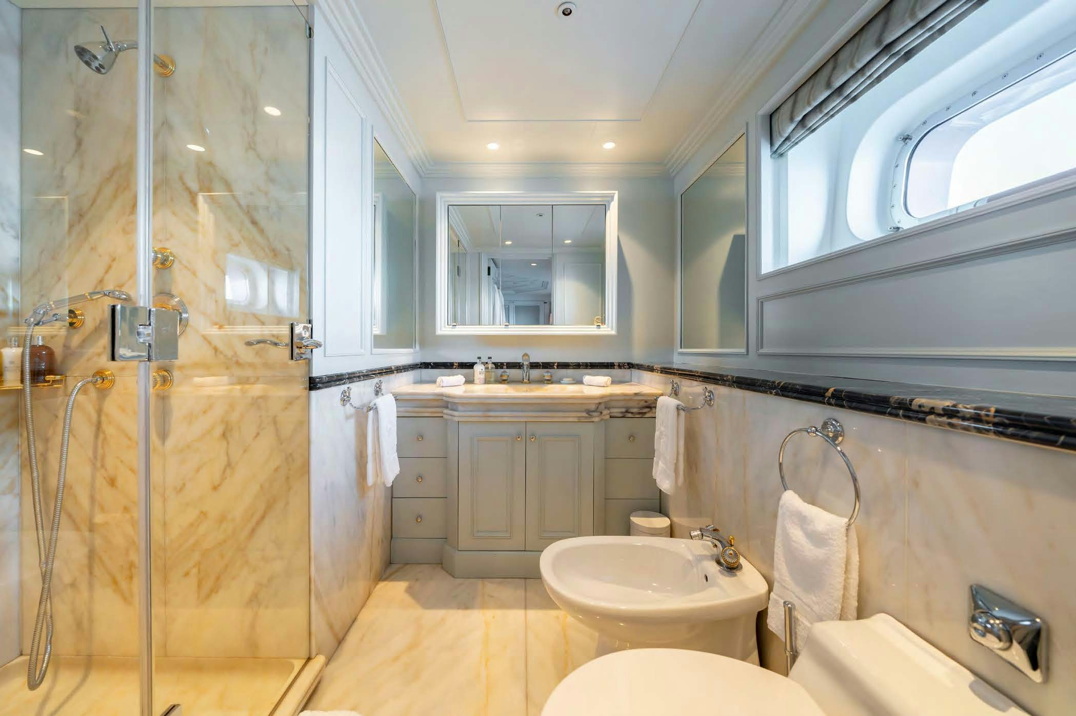 a bathroom with a glass shower aboard MOSAIQUE Yacht for Sale