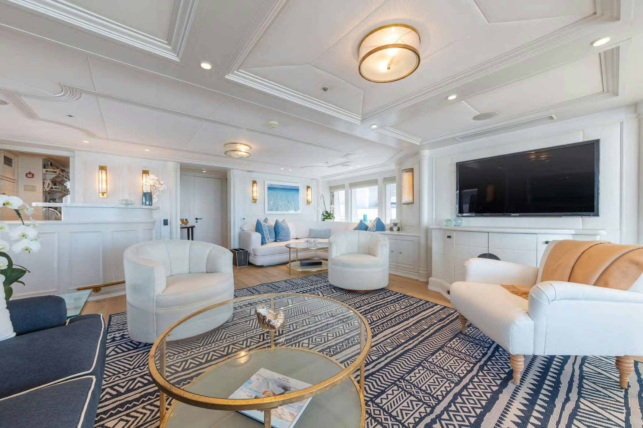a living room with a large screen aboard MOSAIQUE Yacht for Sale