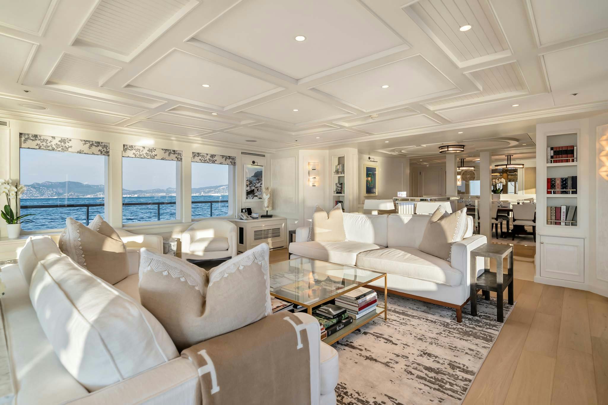 a living room with a large window aboard MOSAIQUE Yacht for Charter
