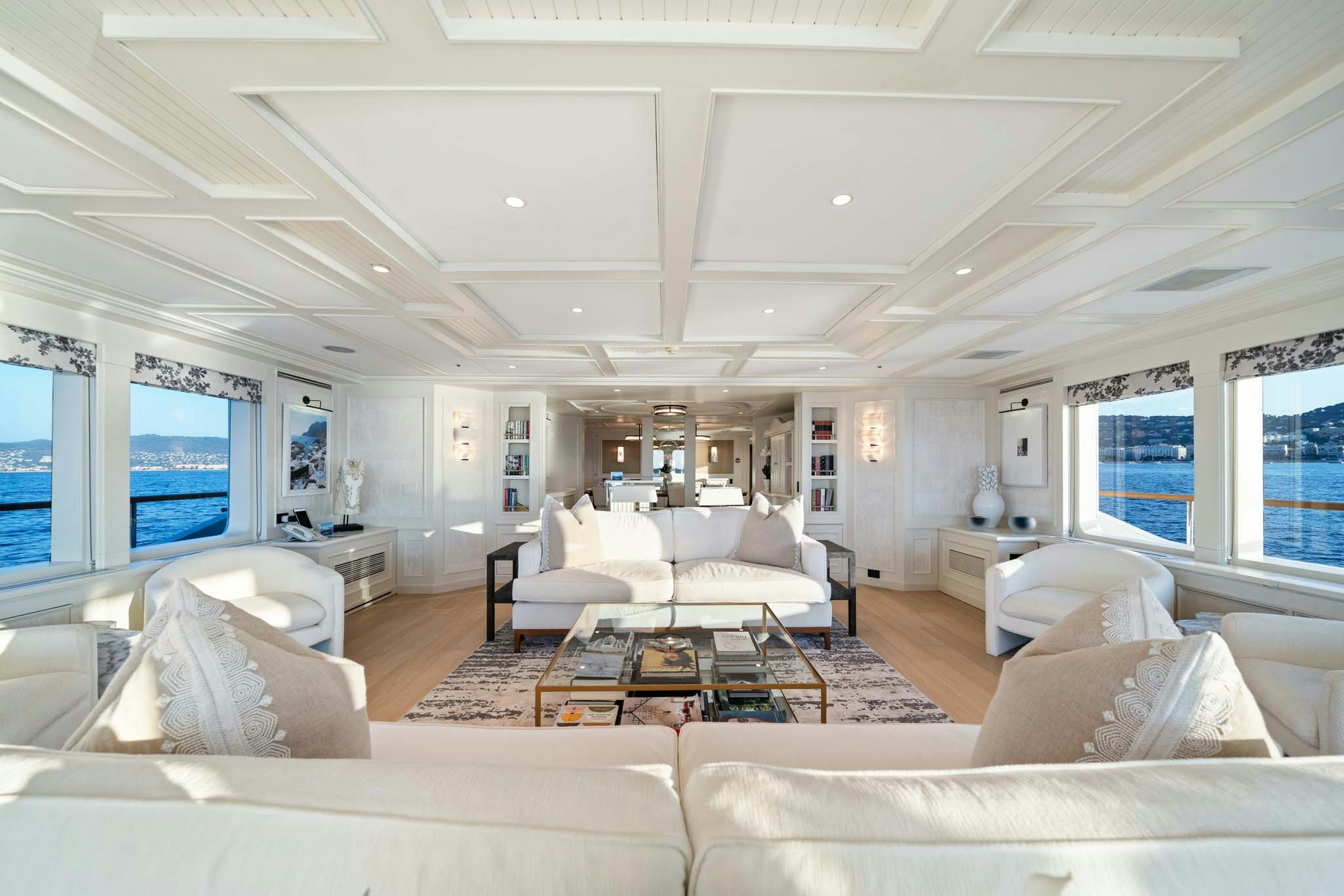 a living room with a large window aboard MOSAIQUE Yacht for Charter