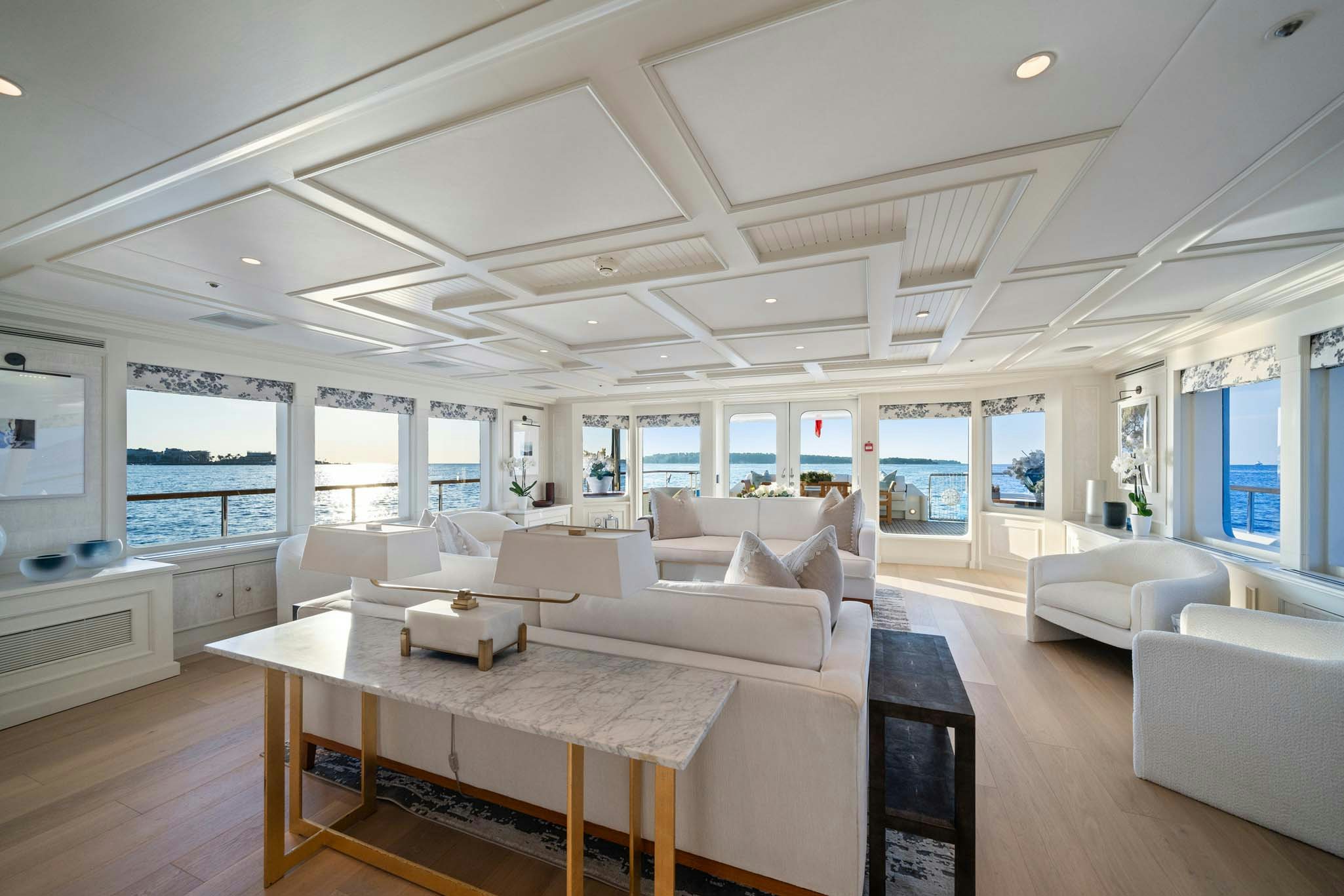 a large living room with a large window aboard MOSAIQUE Yacht for Charter