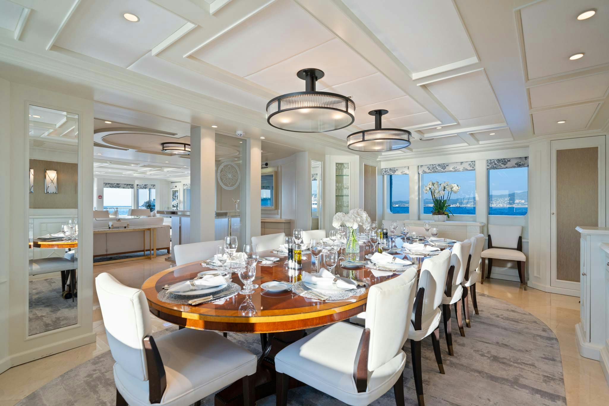 a dining room with a table and chairs aboard MOSAIQUE Yacht for Charter