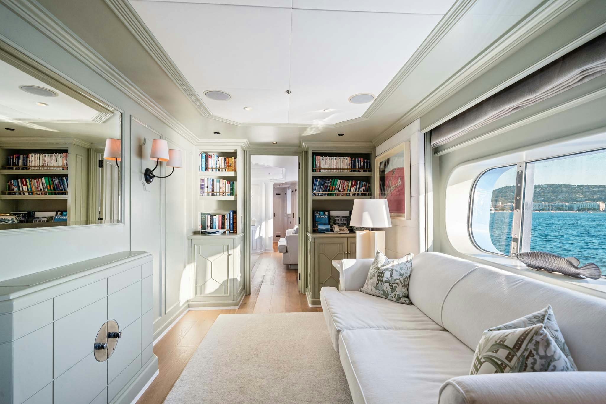 a living room with a large window aboard MOSAIQUE Yacht for Charter