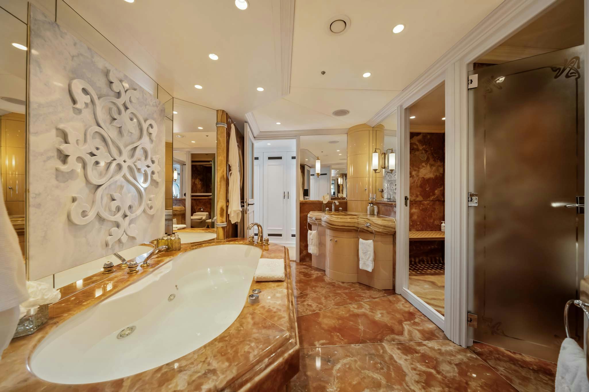 a large bathroom with marble tiles aboard MOSAIQUE Yacht for Charter