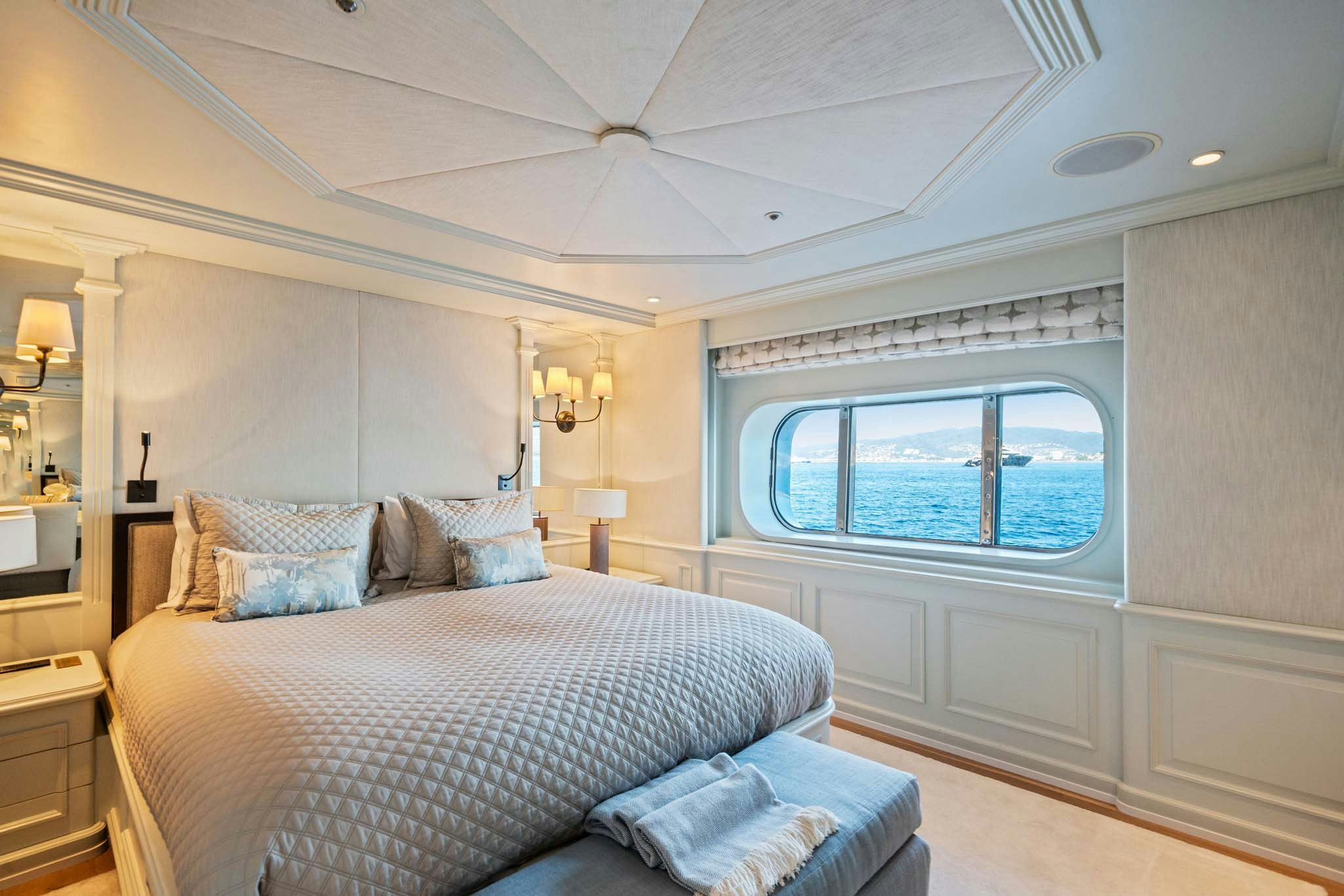 a bedroom with a large bed aboard MOSAIQUE Yacht for Charter