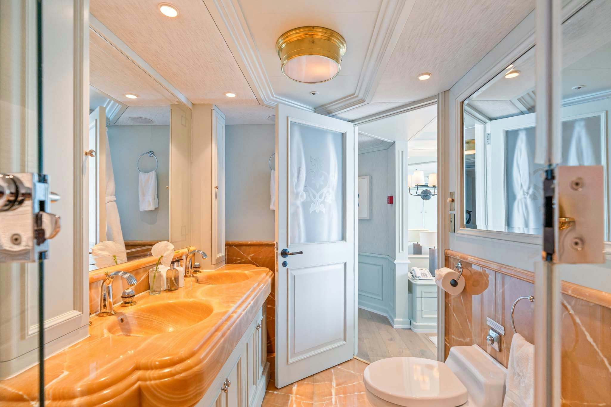 a bathroom with a large mirror aboard MOSAIQUE Yacht for Charter
