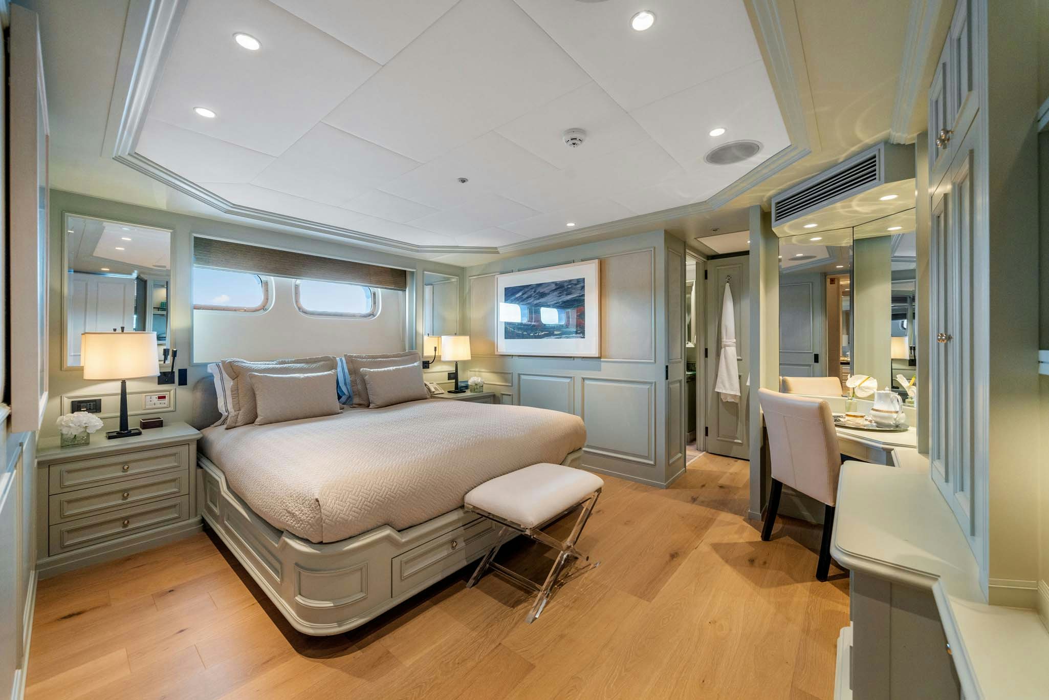 a bedroom with a bed and a table aboard MOSAIQUE Yacht for Charter