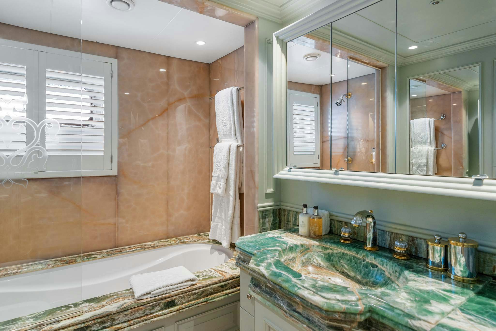 a bathroom with a large mirror aboard MOSAIQUE Yacht for Charter