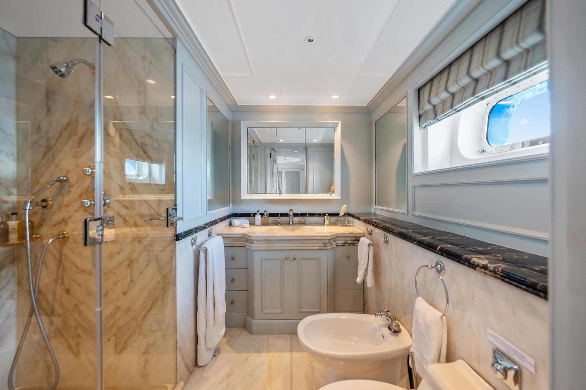 a bathroom with a glass shower aboard MOSAIQUE Yacht for Charter