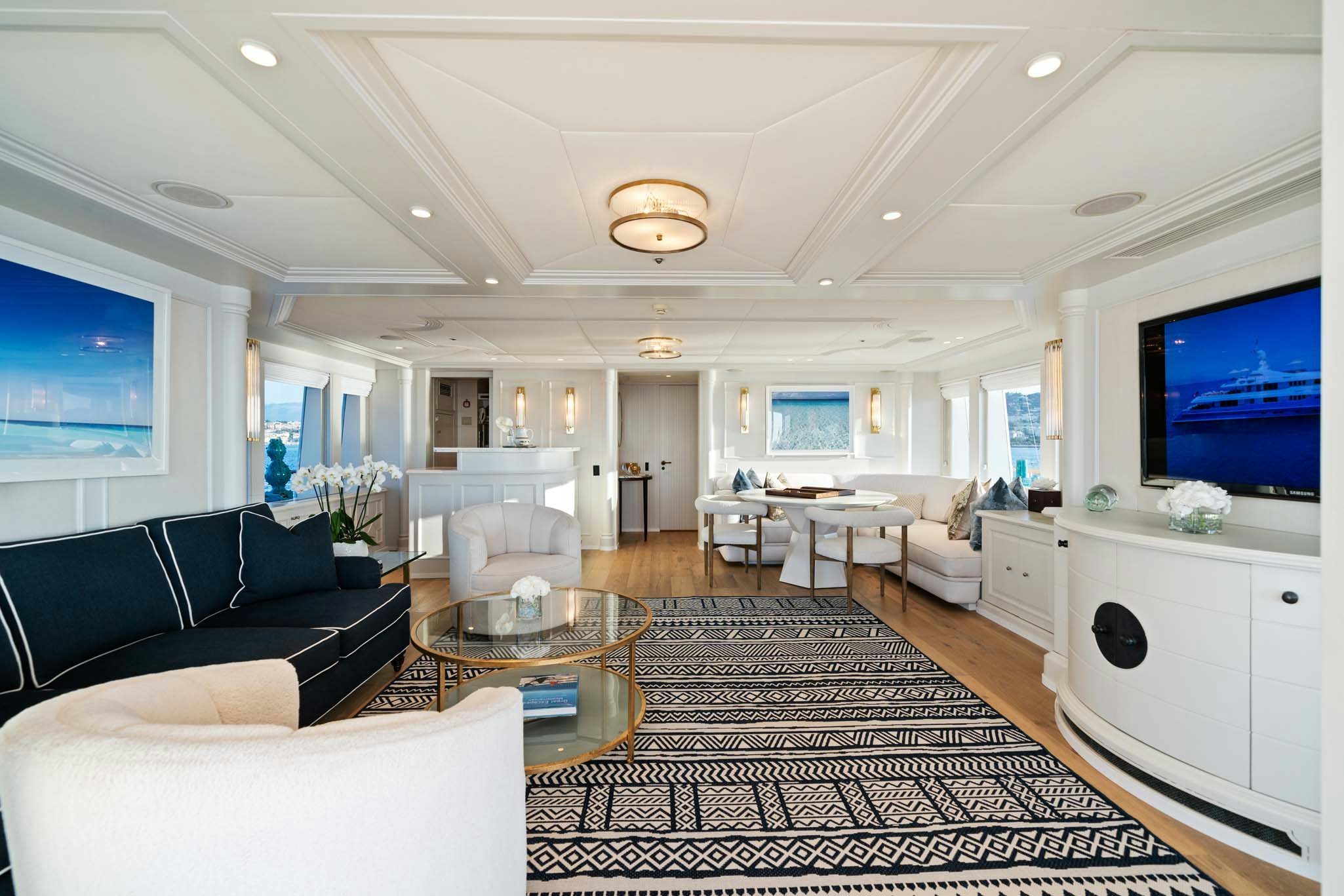 a living room with a large screen aboard MOSAIQUE Yacht for Charter