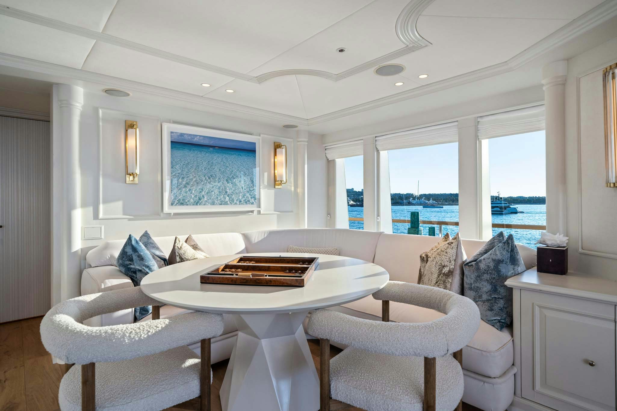 a living room with a large window aboard MOSAIQUE Yacht for Charter