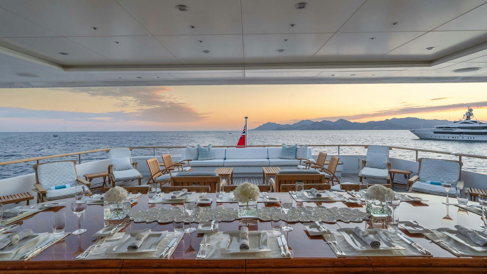 a room with tables and chairs aboard MOSAIQUE Yacht for Charter