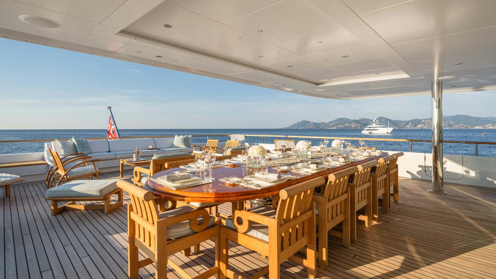a table set for a dinner party aboard MOSAIQUE Yacht for Charter