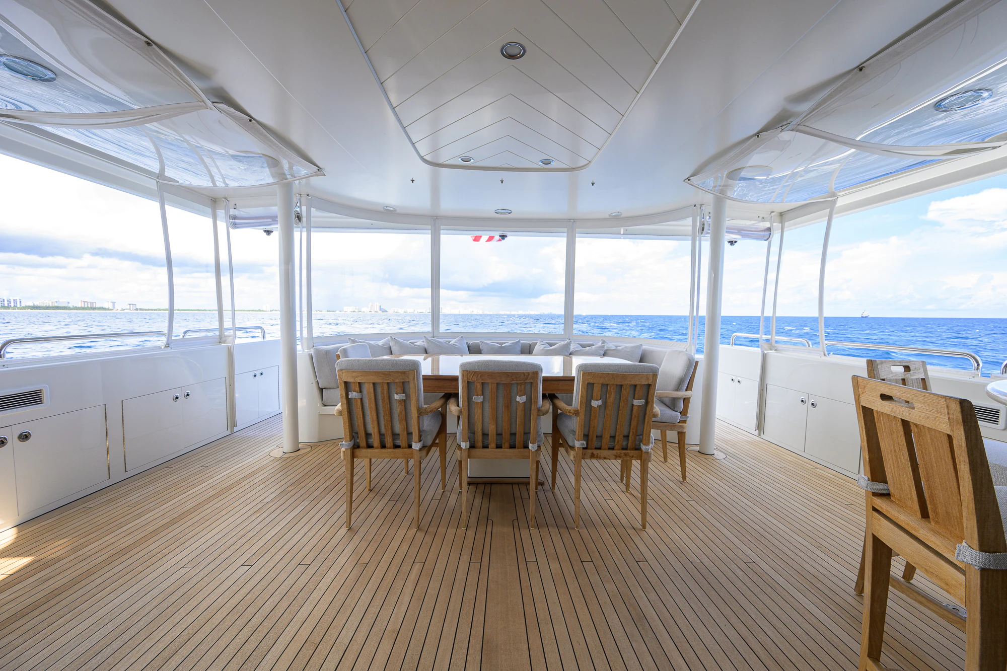a large room with a table and chairs aboard BREEZY DAY Yacht for Sale