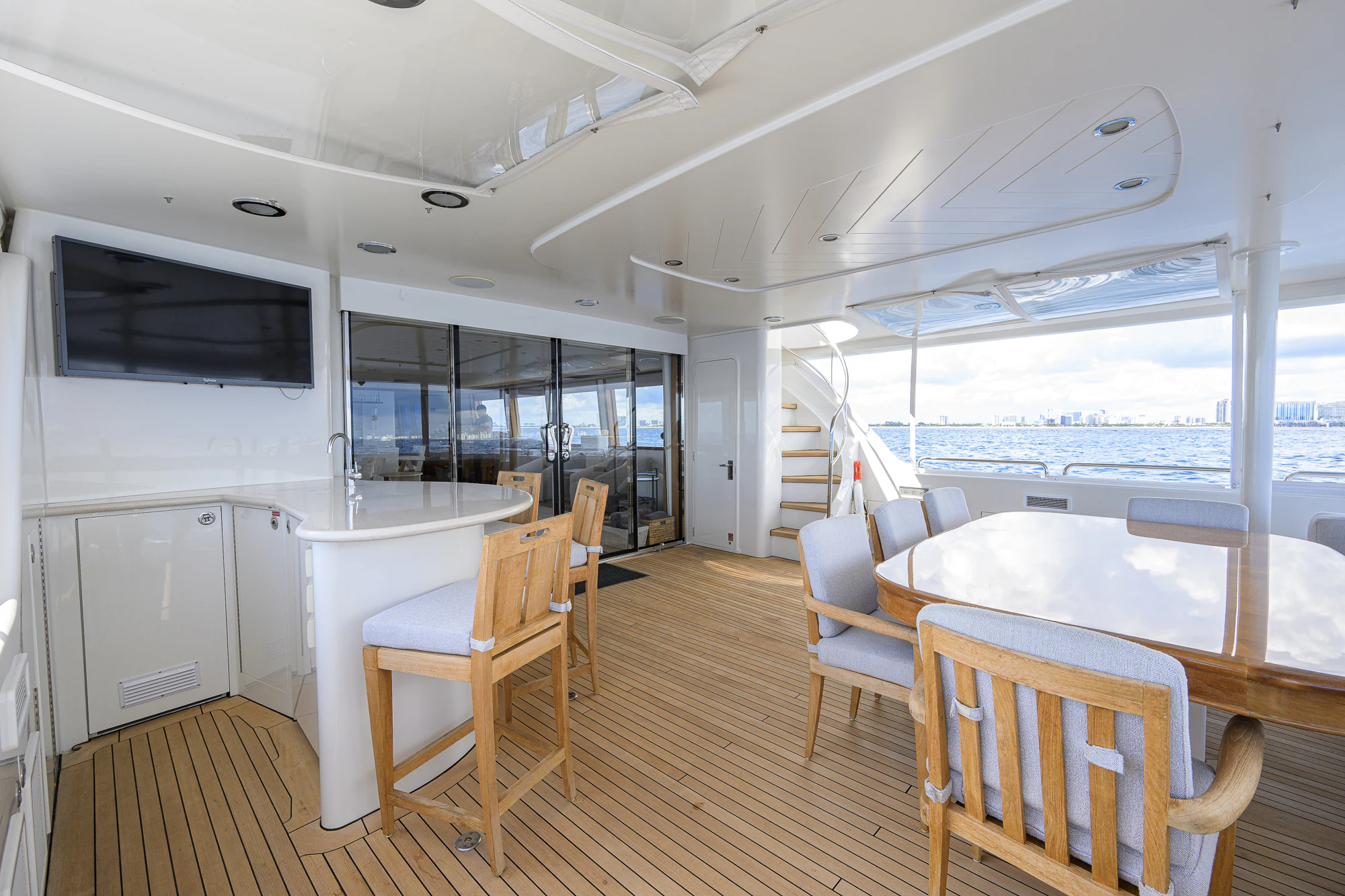 a large white room with a table and chairs aboard BREEZY DAY Yacht for Sale