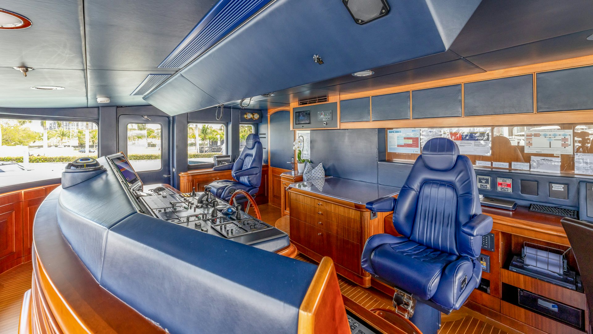 a room with a couple of people in blue chairs aboard FOCUS Yacht for Sale