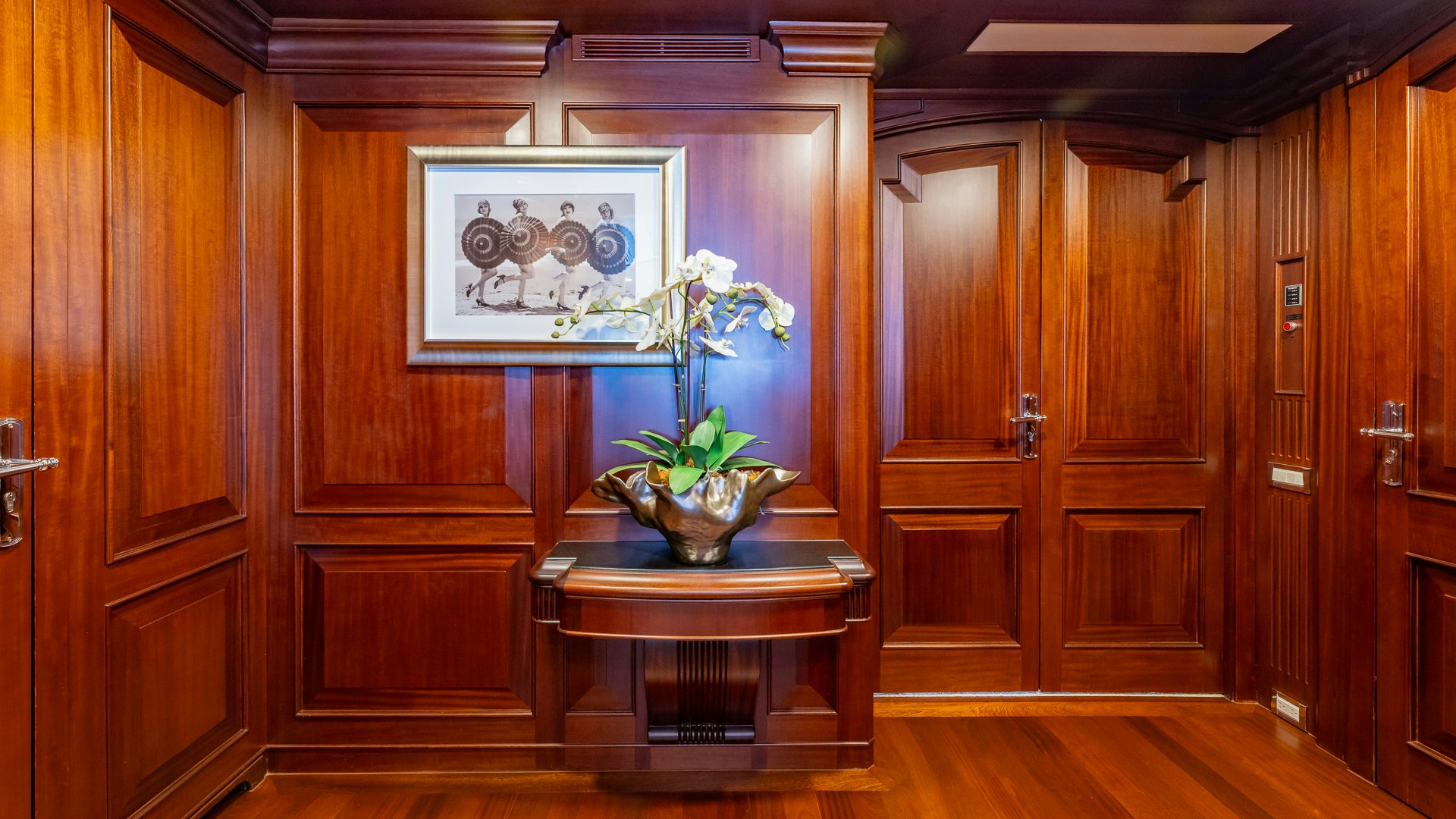 a wooden cabinet with a painting on it aboard FOCUS Yacht for Sale