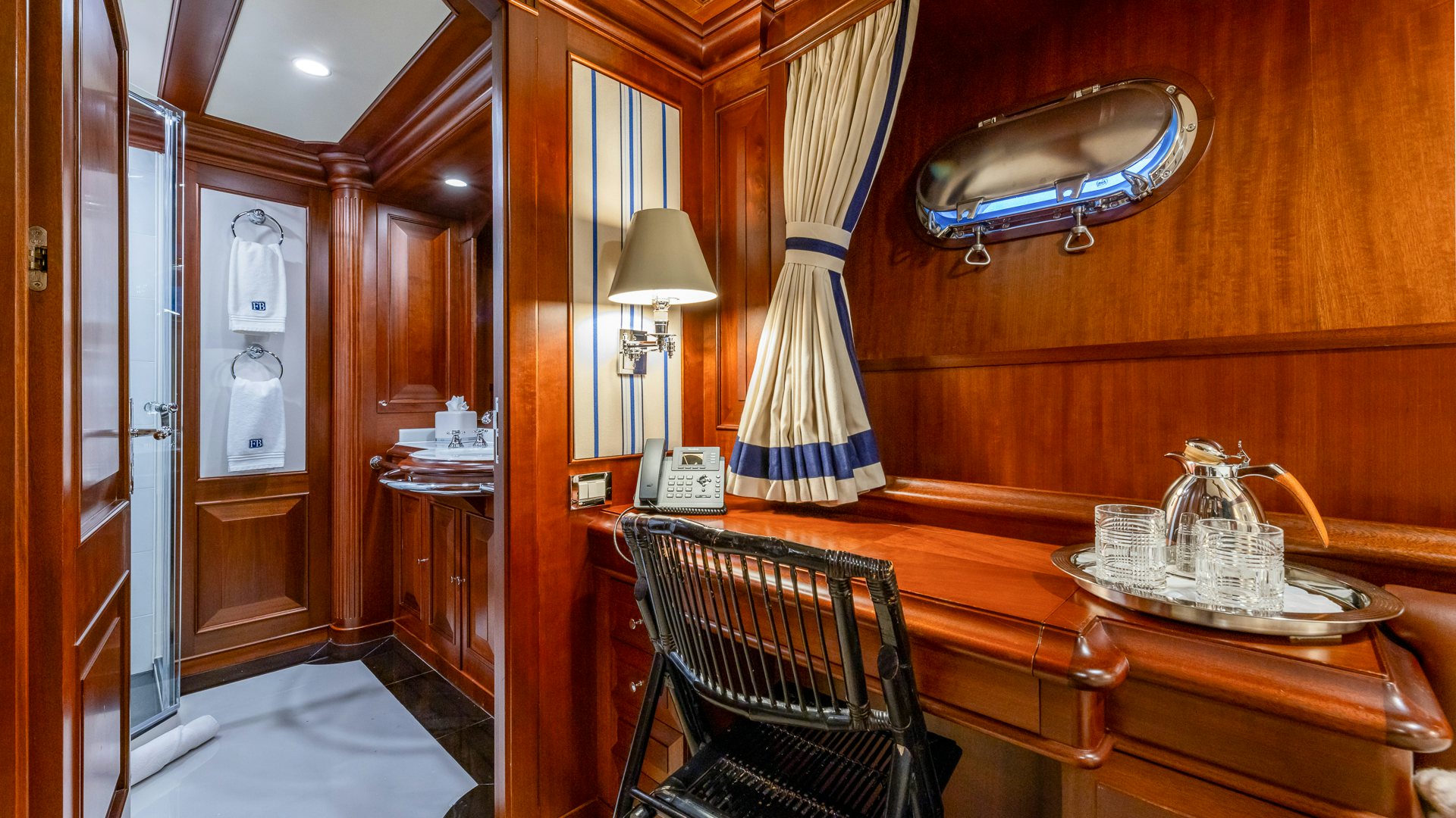 a dining room with a table and a lamp aboard FOCUS Yacht for Sale