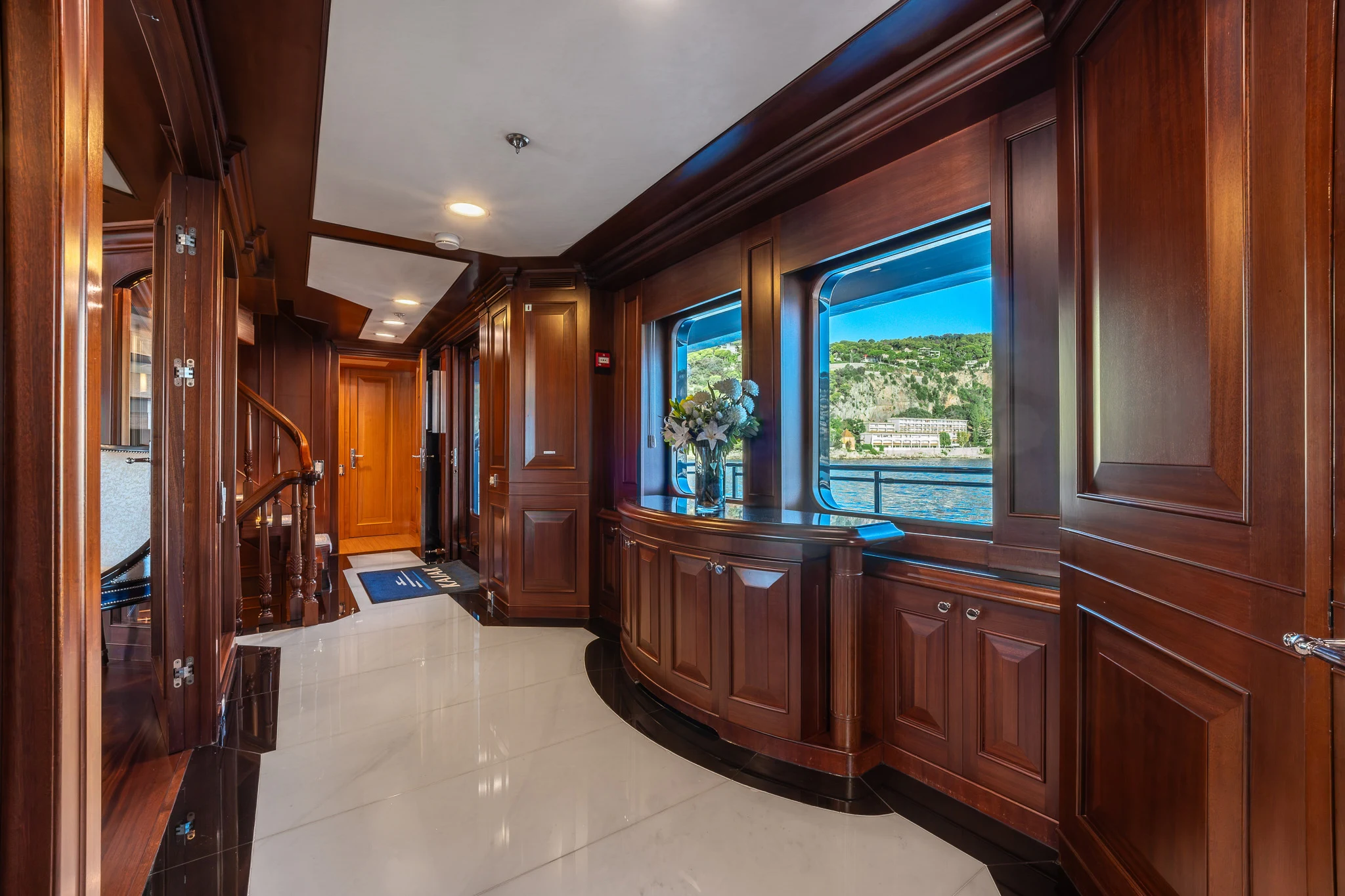 a kitchen with wooden cabinets aboard KAJAK Yacht for Sale