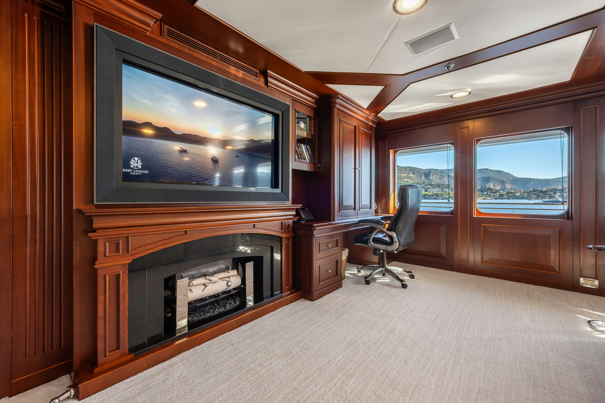 a living room with a fireplace aboard KAJAK Yacht for Sale