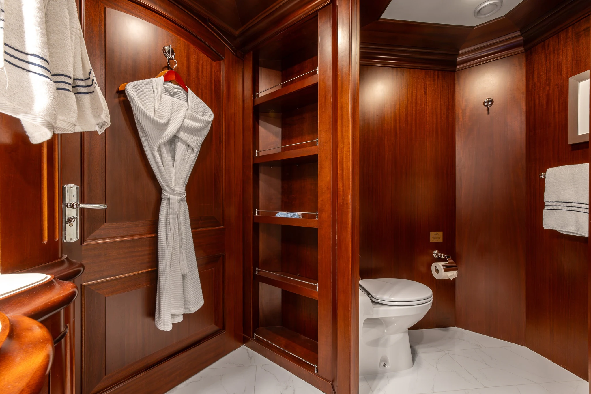 a bathroom with a robe on the wall aboard KAJAK Yacht for Sale