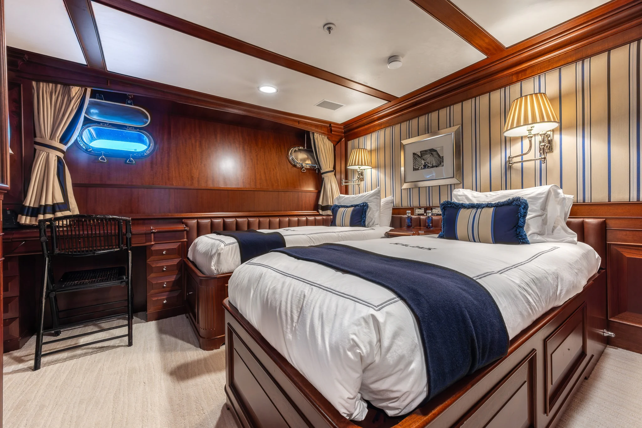 a bedroom with a bed and a desk aboard KAJAK Yacht for Sale