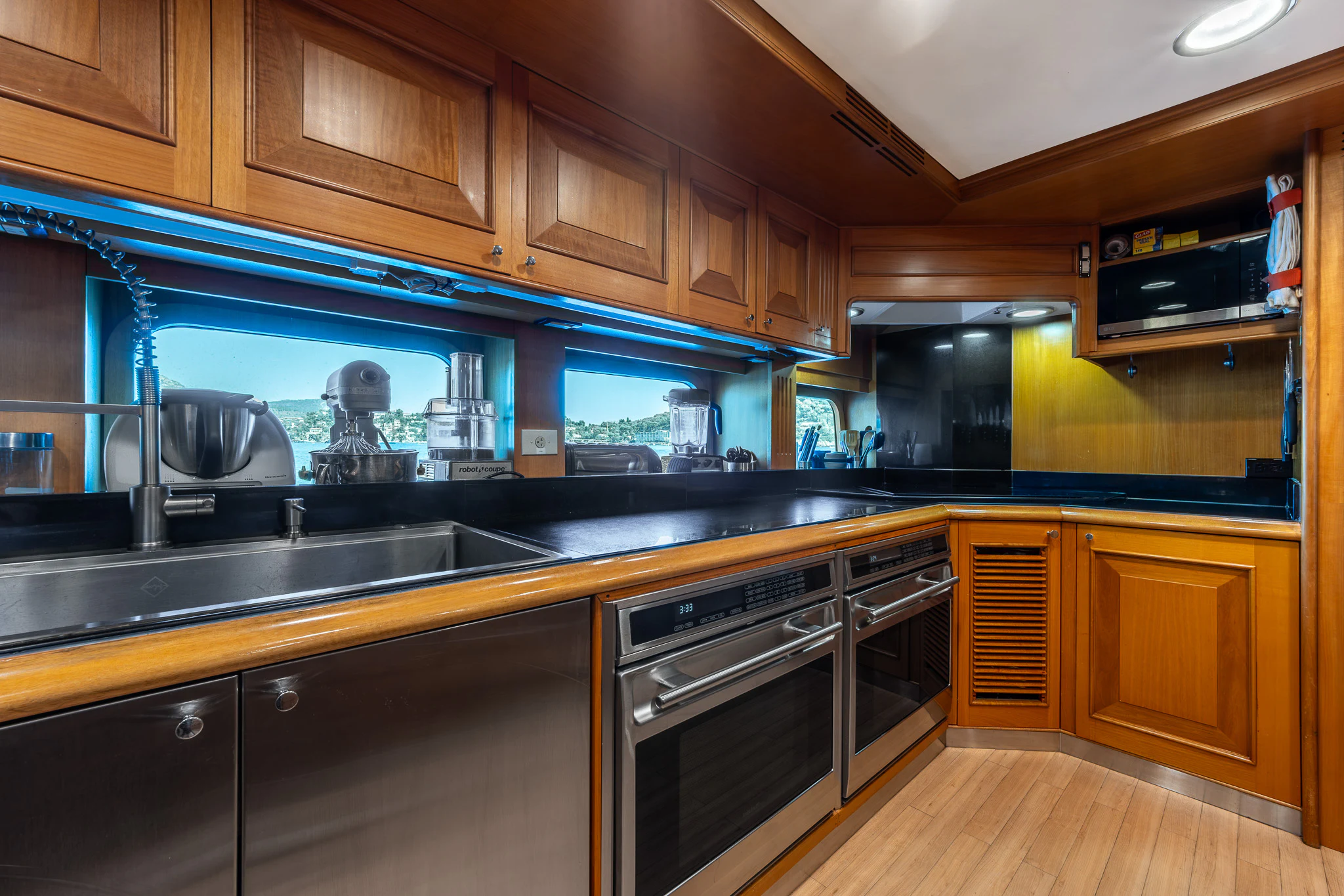 a kitchen with wooden cabinets aboard KAJAK Yacht for Sale