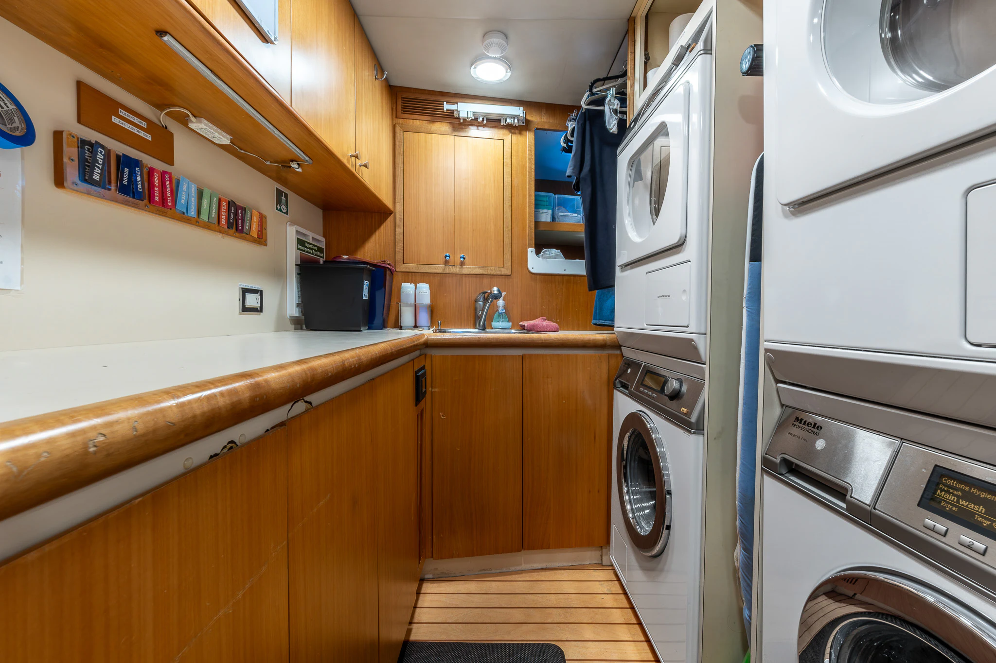 a kitchen with a washing machine and cabinets aboard KAJAK Yacht for Sale