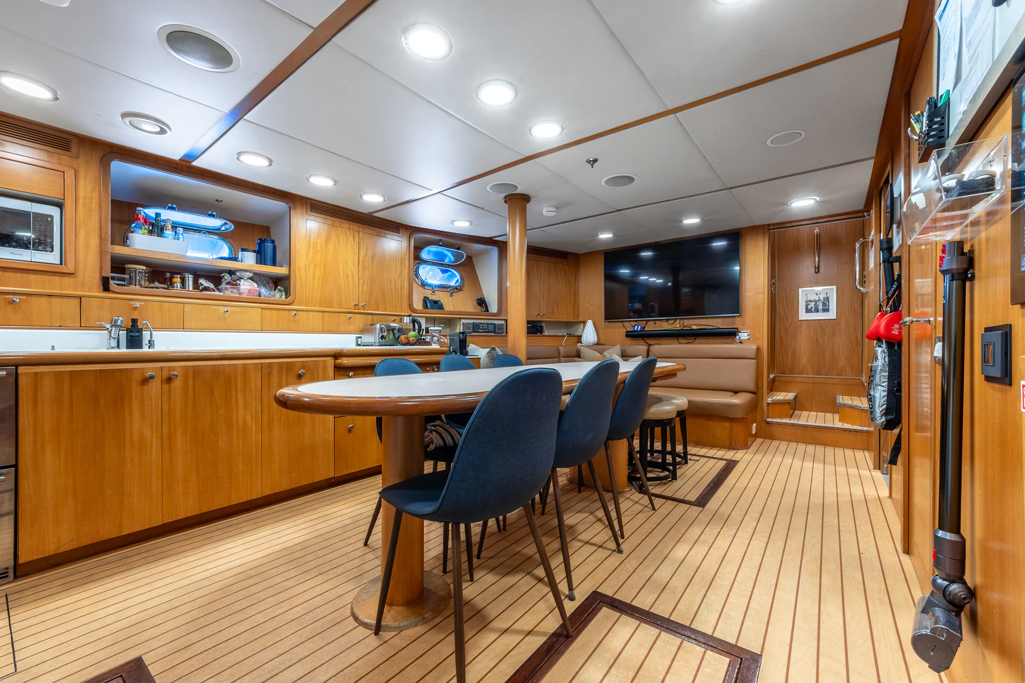 a room with a table and chairs aboard KAJAK Yacht for Sale