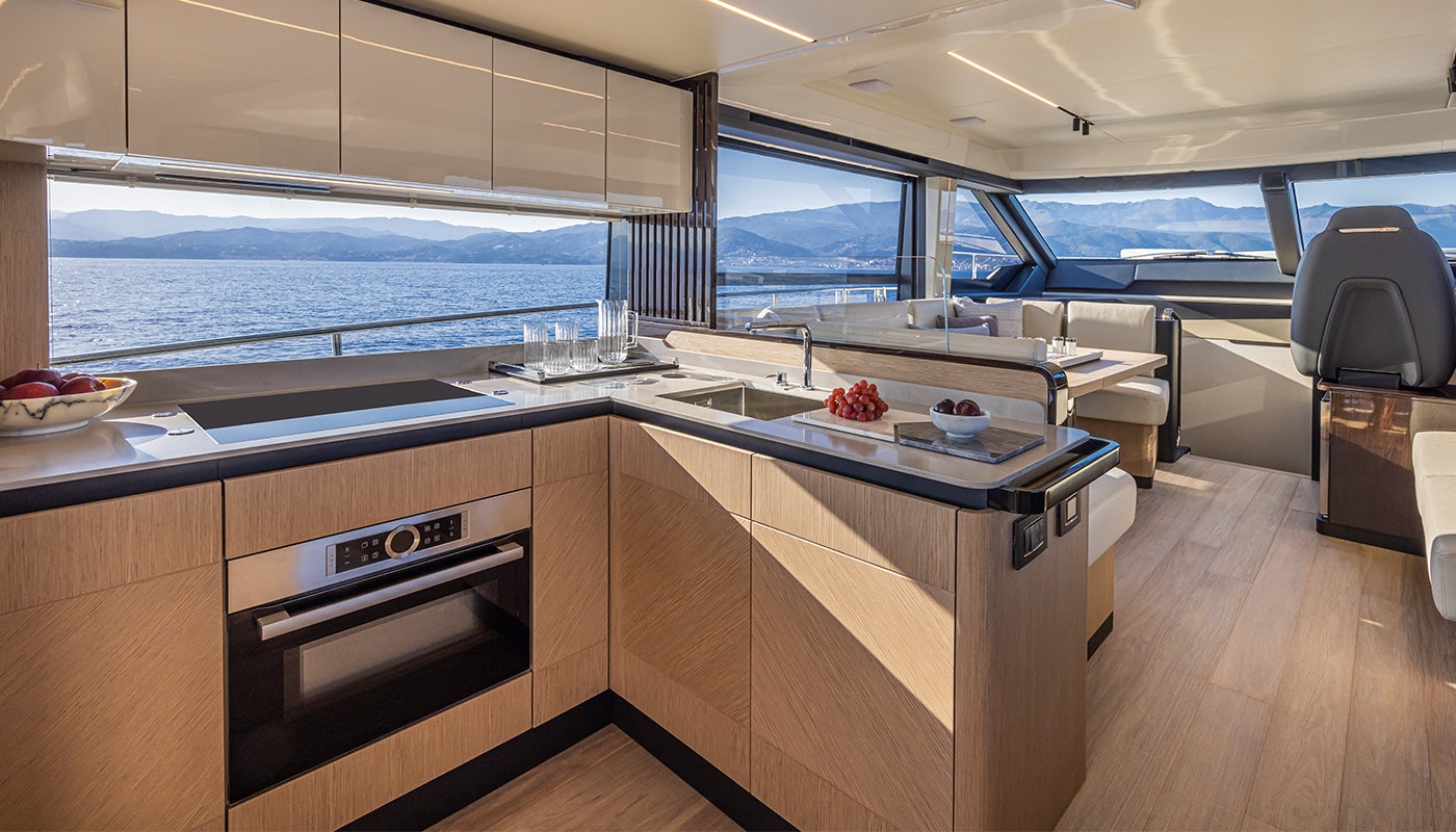 a kitchen with a large window overlooking the ocean aboard ABSOLUTE 56 FLYBRIDGE Yacht for Sale