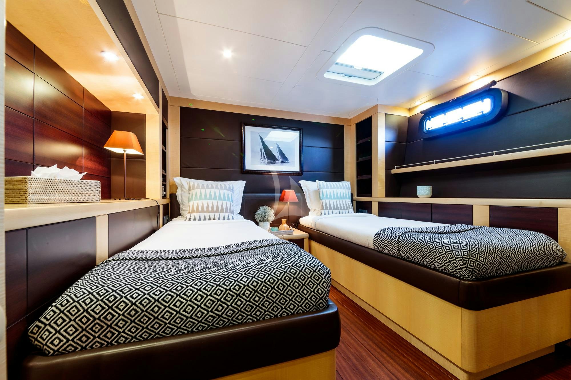 a room with two beds aboard ALLURES Yacht for Charter