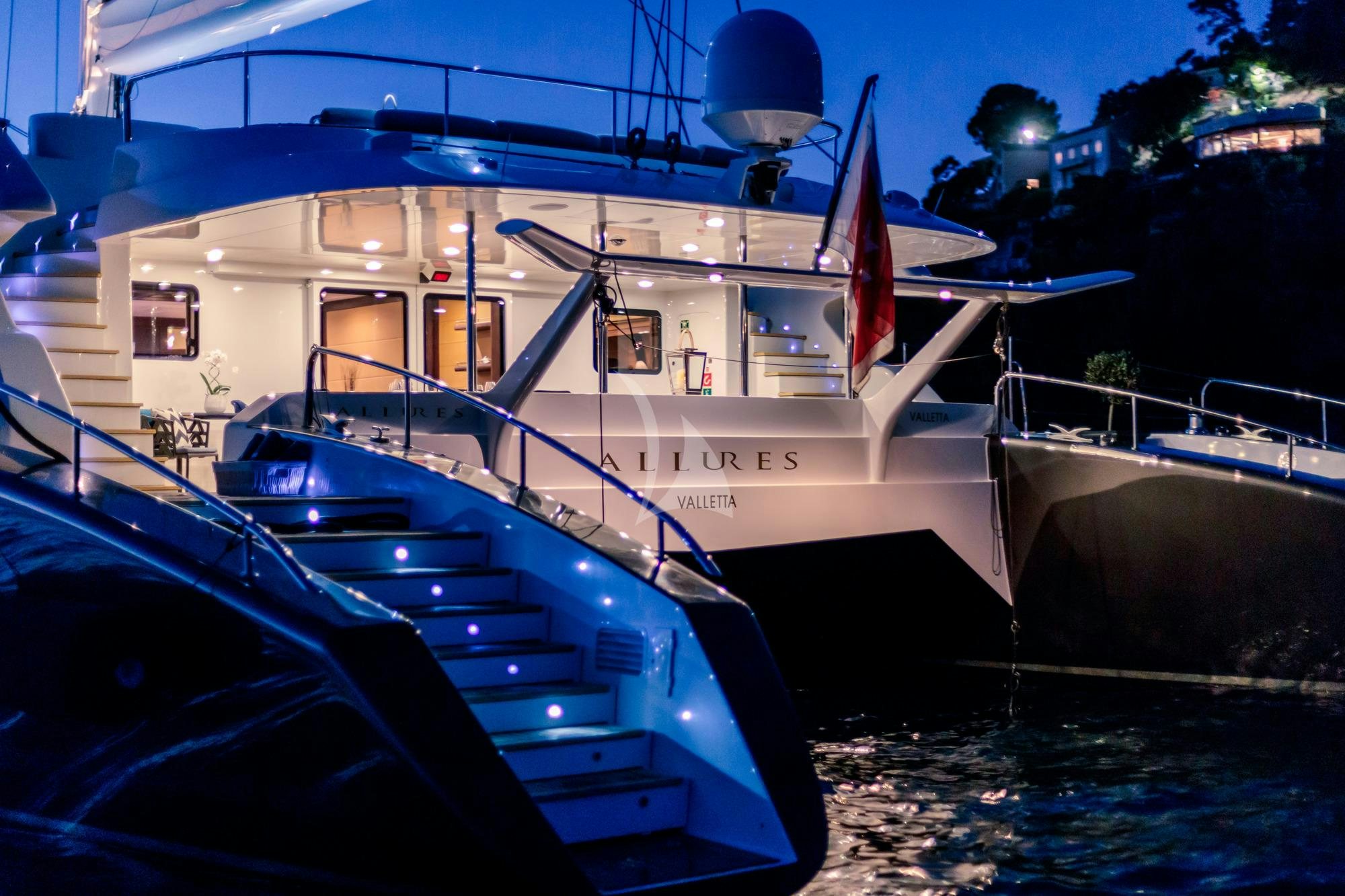 a boat docked at night aboard ALLURES Yacht for Charter