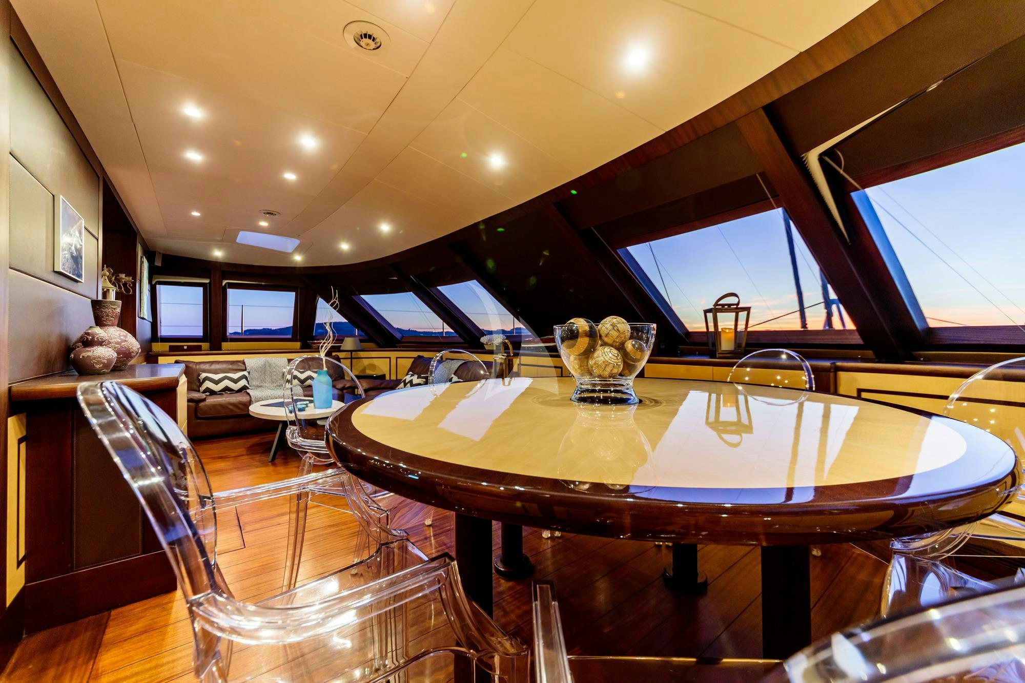 a large dining table in a room aboard ALLURES Yacht for Charter