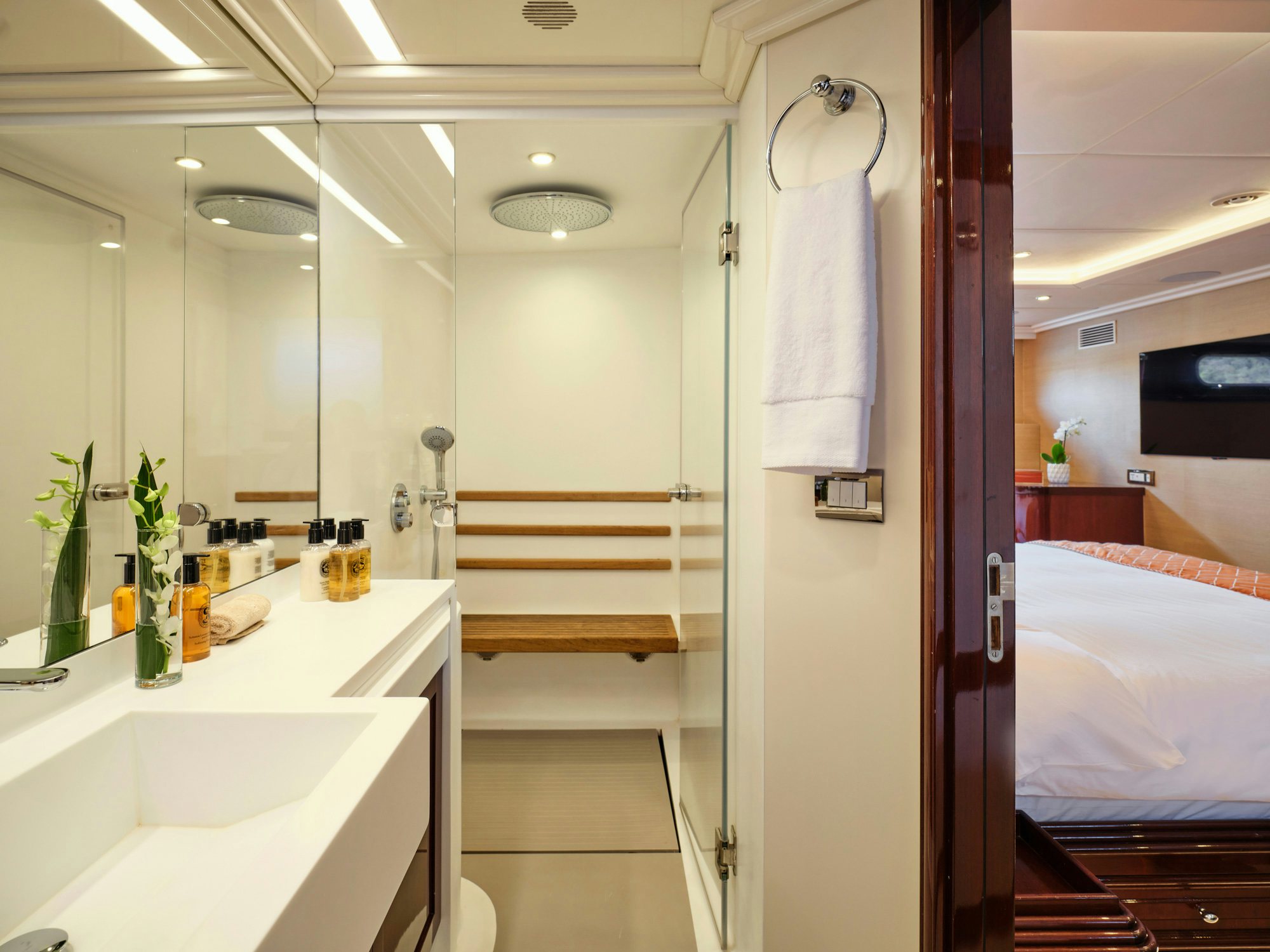a bathroom with a sink and a bed aboard MIA ZOI Yacht for Charter