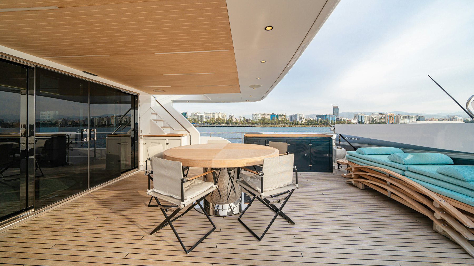 a deck with a table and chairs aboard CAPE COD II Yacht for Sale