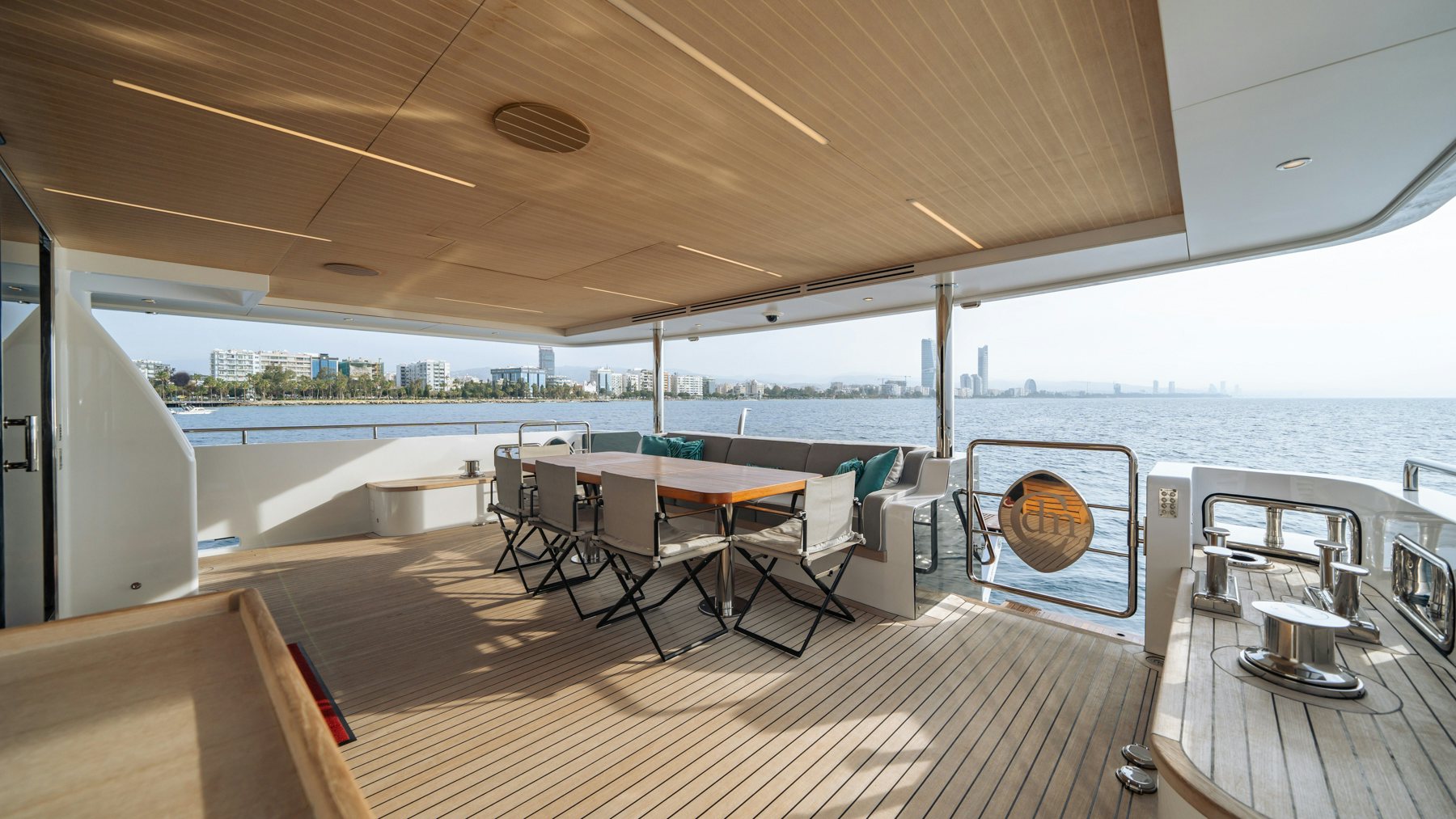 a deck with a table and chairs aboard CAPE COD II Yacht for Sale